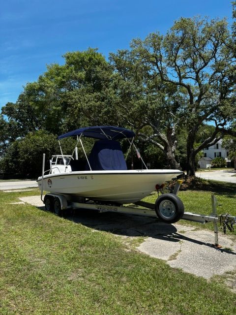 A 2008 Boston Whaler 200 Dauntless on a trailer, parked on grass.