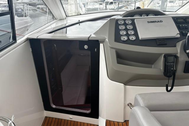 Cockpit of 2013 Beneteau Gran Turismo 38 with Simrad navigation system and teak flooring.