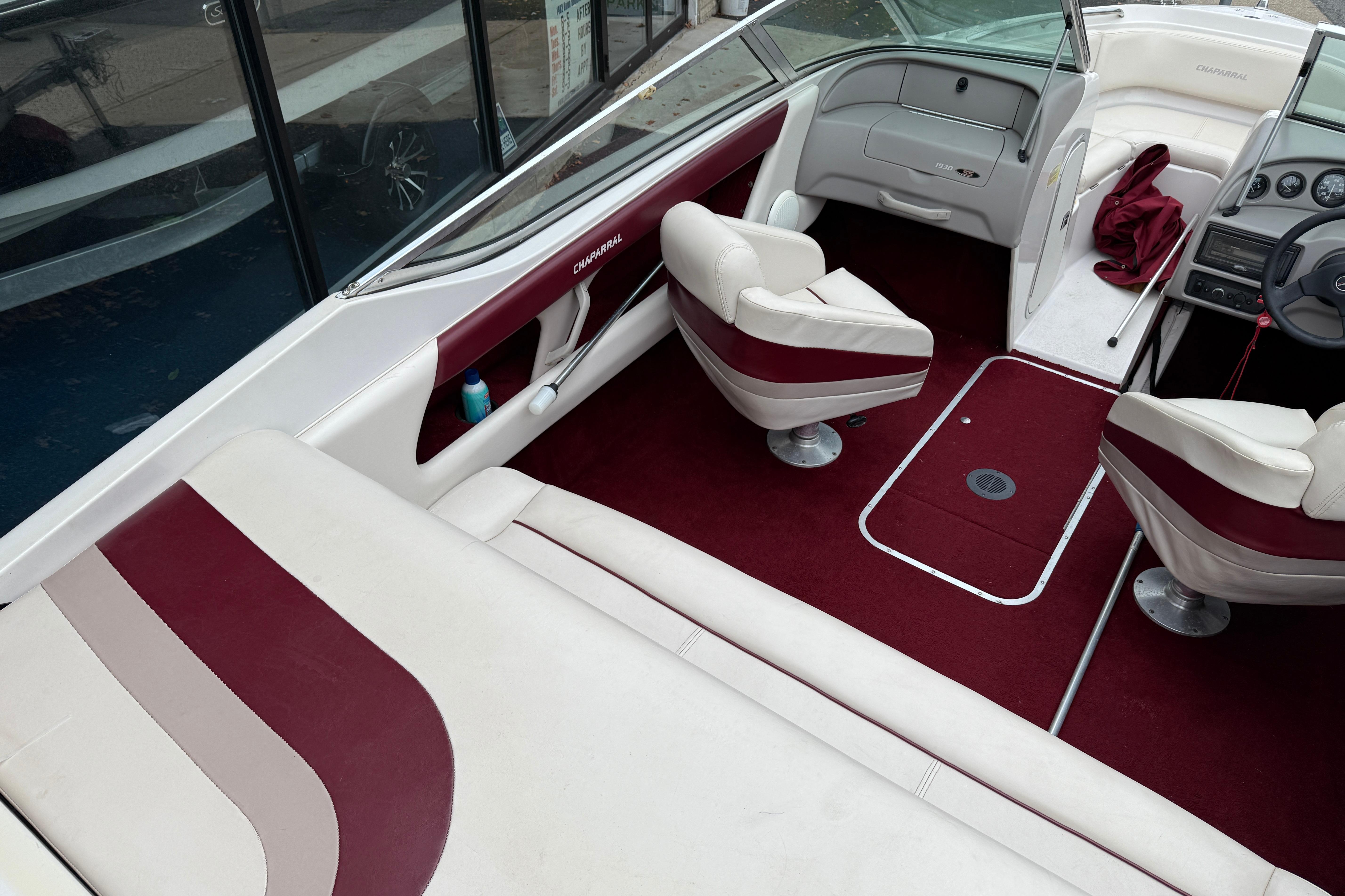 Interior of a 1999 Chaparral 1930 SS boat with maroon and white seating.