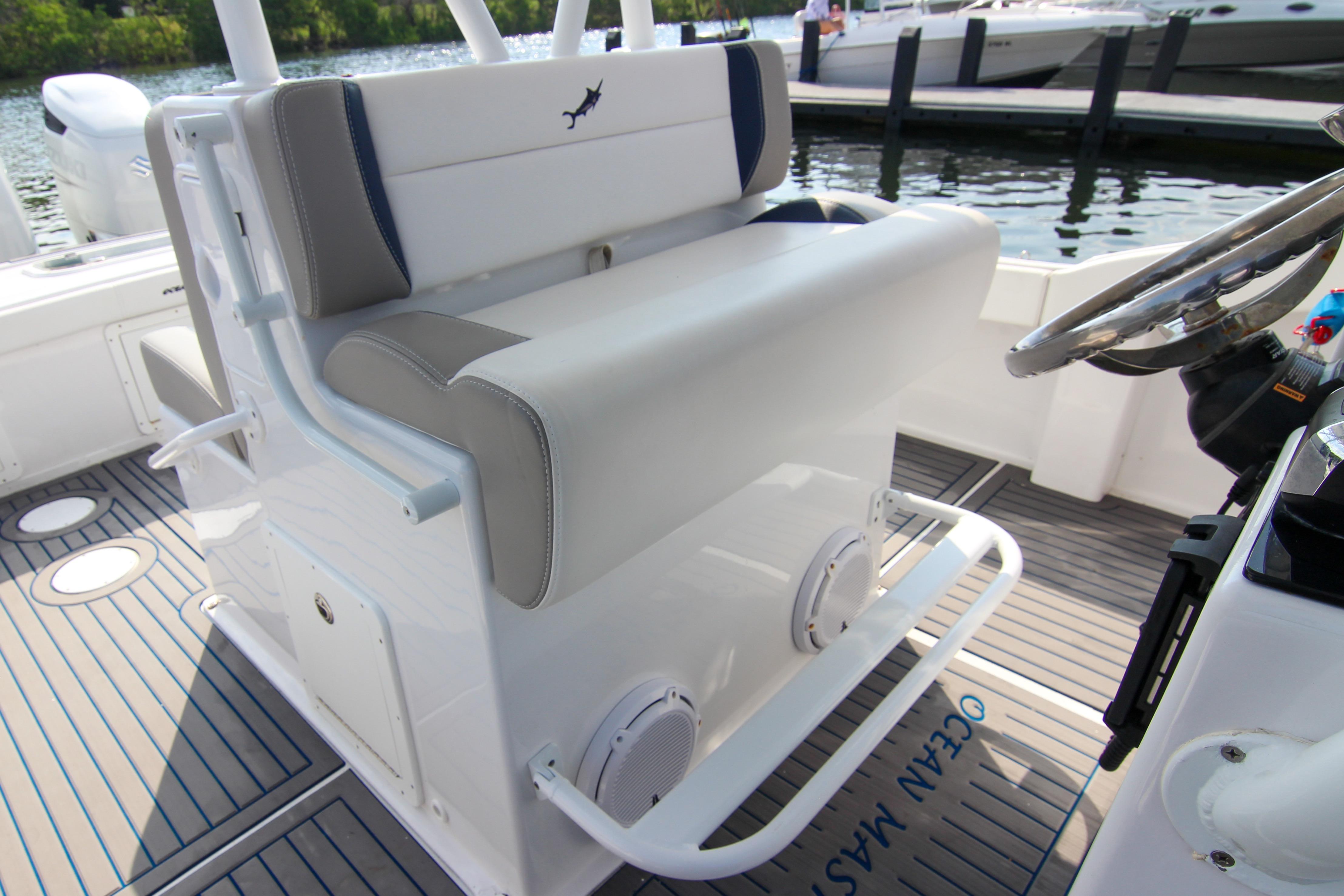 1996 Ocean Master 31 Center Console boat interior with cushioned seating and steering wheel.