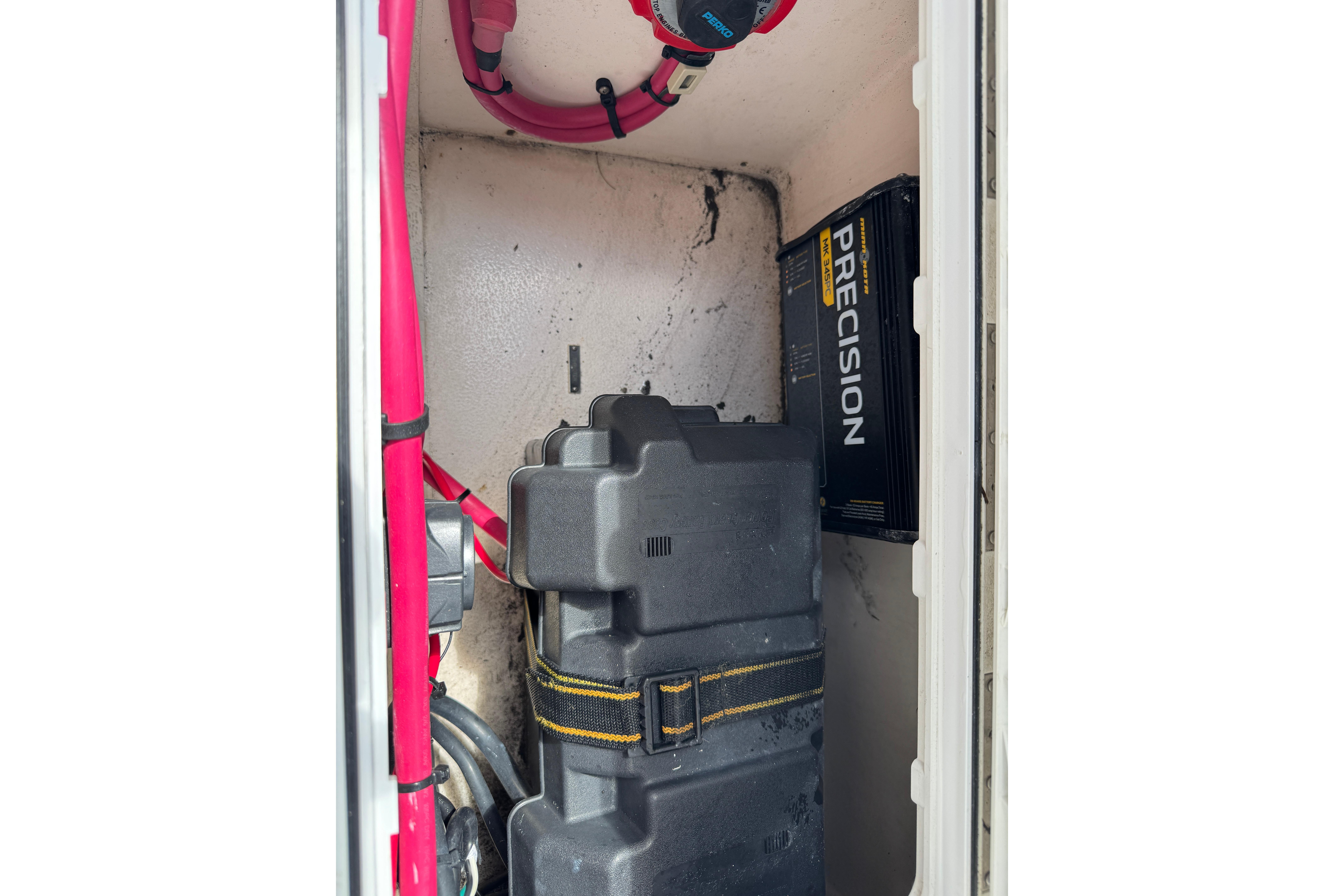 2001 Intrepid 339 Walkaround battery compartment with Precision charger and cables.