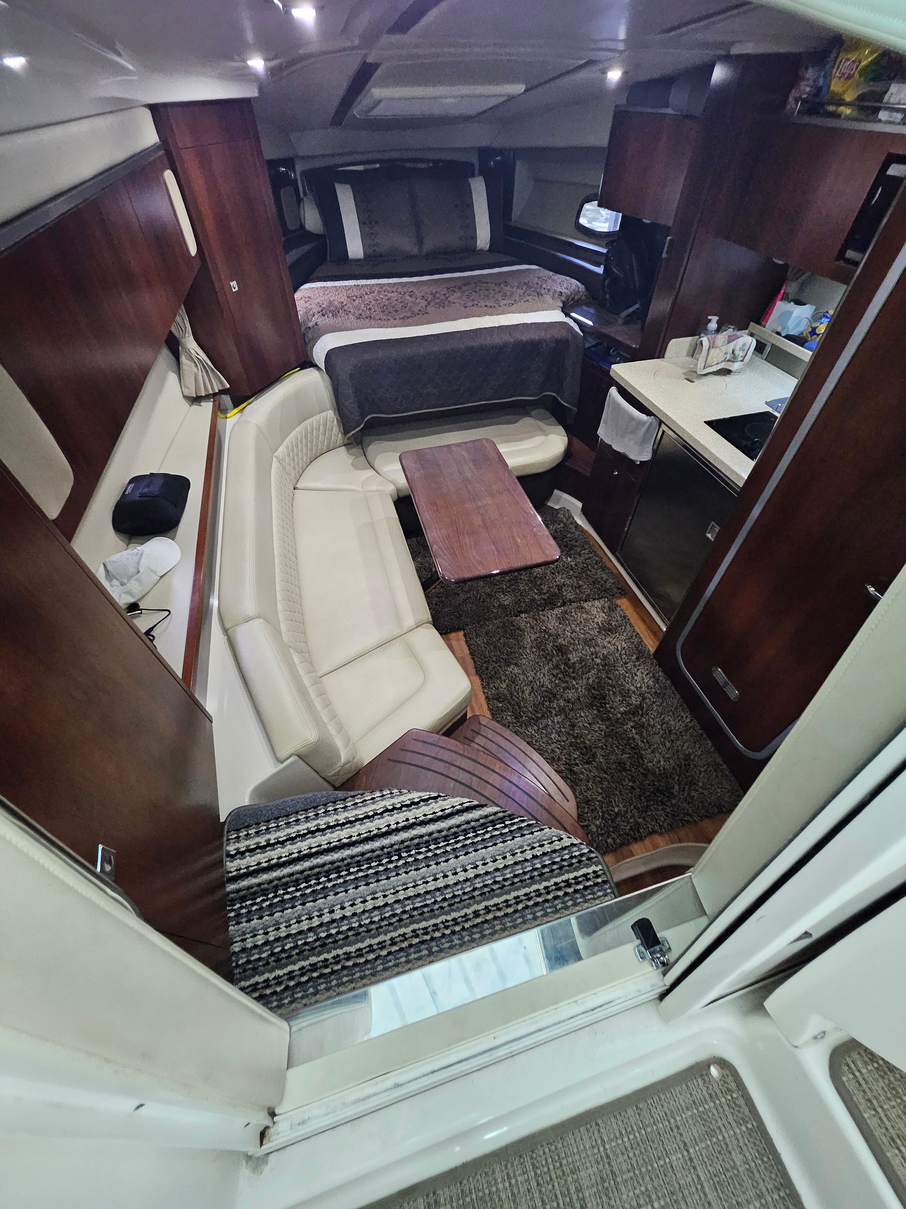 Interior of a 2014 Chaparral 330 Signature yacht with cozy living area.