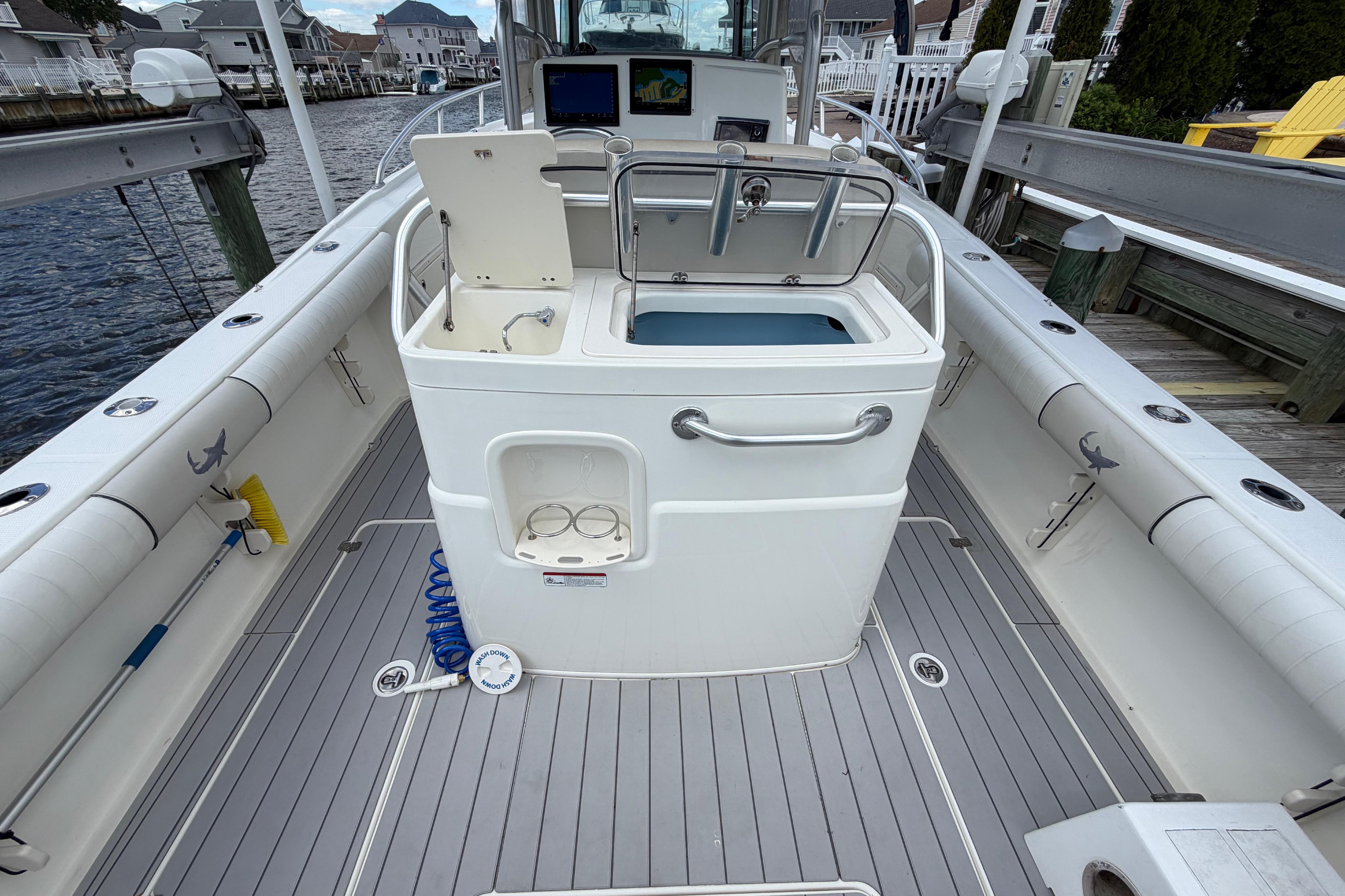 2017 Mako 284 Center Console boat interior with fishing equipment and storage.