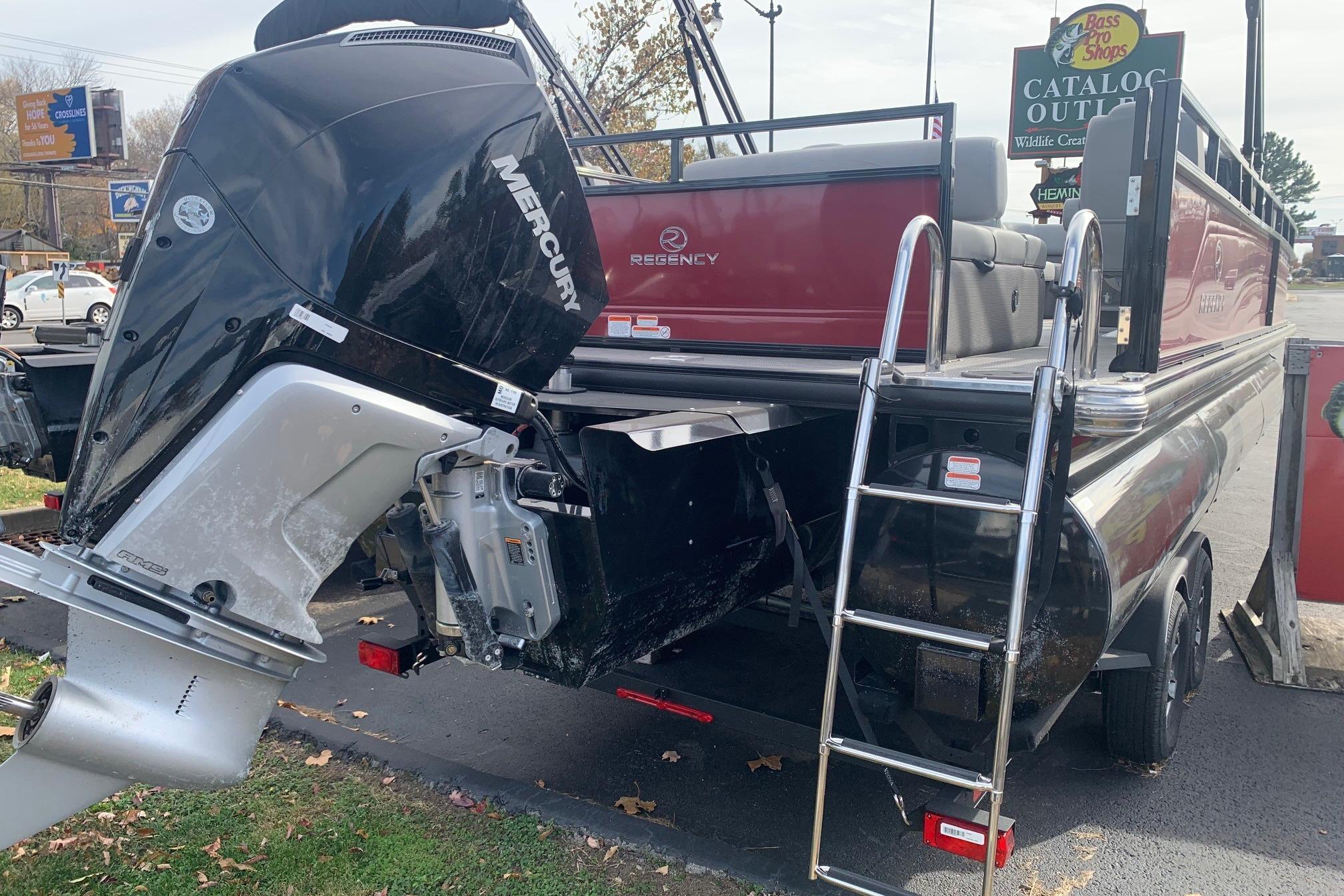 2024 Regency 250 DL3 pontoon boat with Mercury outboard motor and boarding ladder.