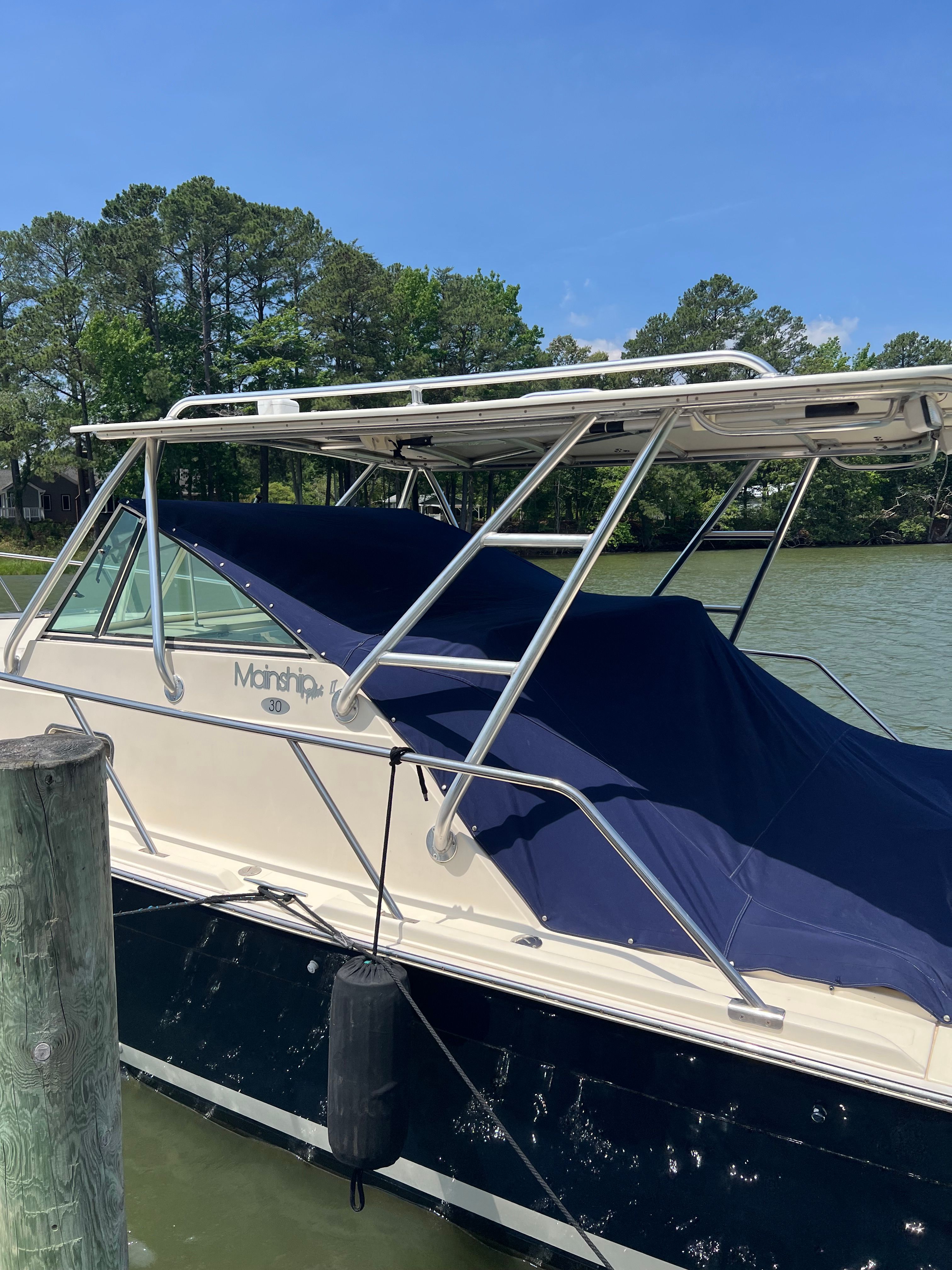 2003 Mainship Pilot 30-II boat docked on a sunny day.