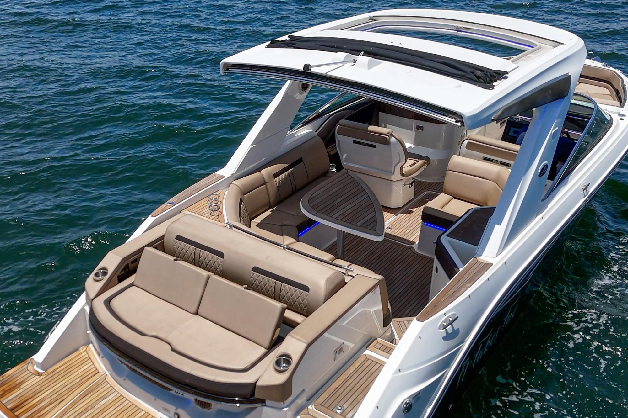 2018 Sea Ray SLX 310 boat with luxurious seating on open water.