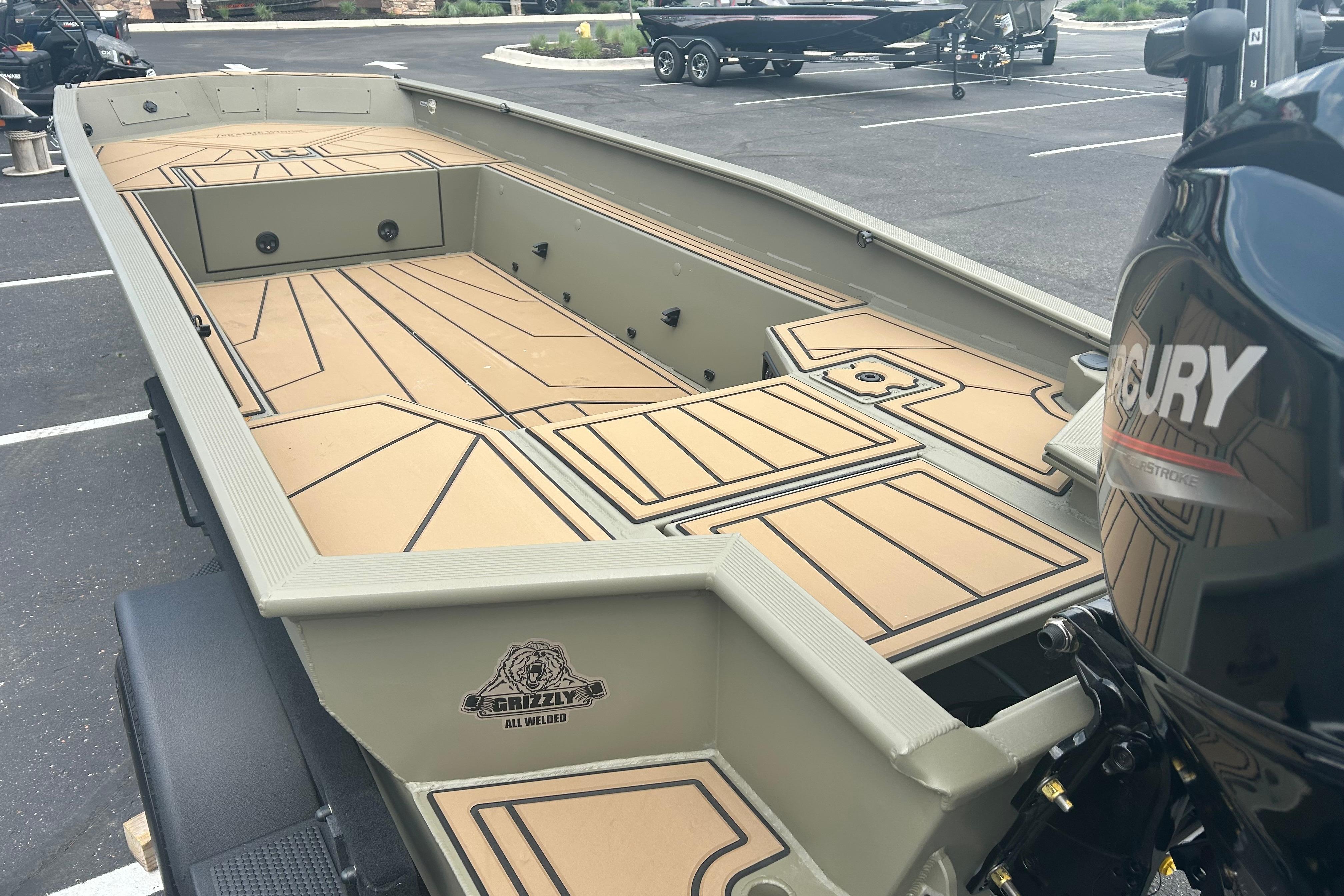 2026 Tracker Grizzly 1650 T Prairie Wings Edition boat with spacious deck and Mercury engine.