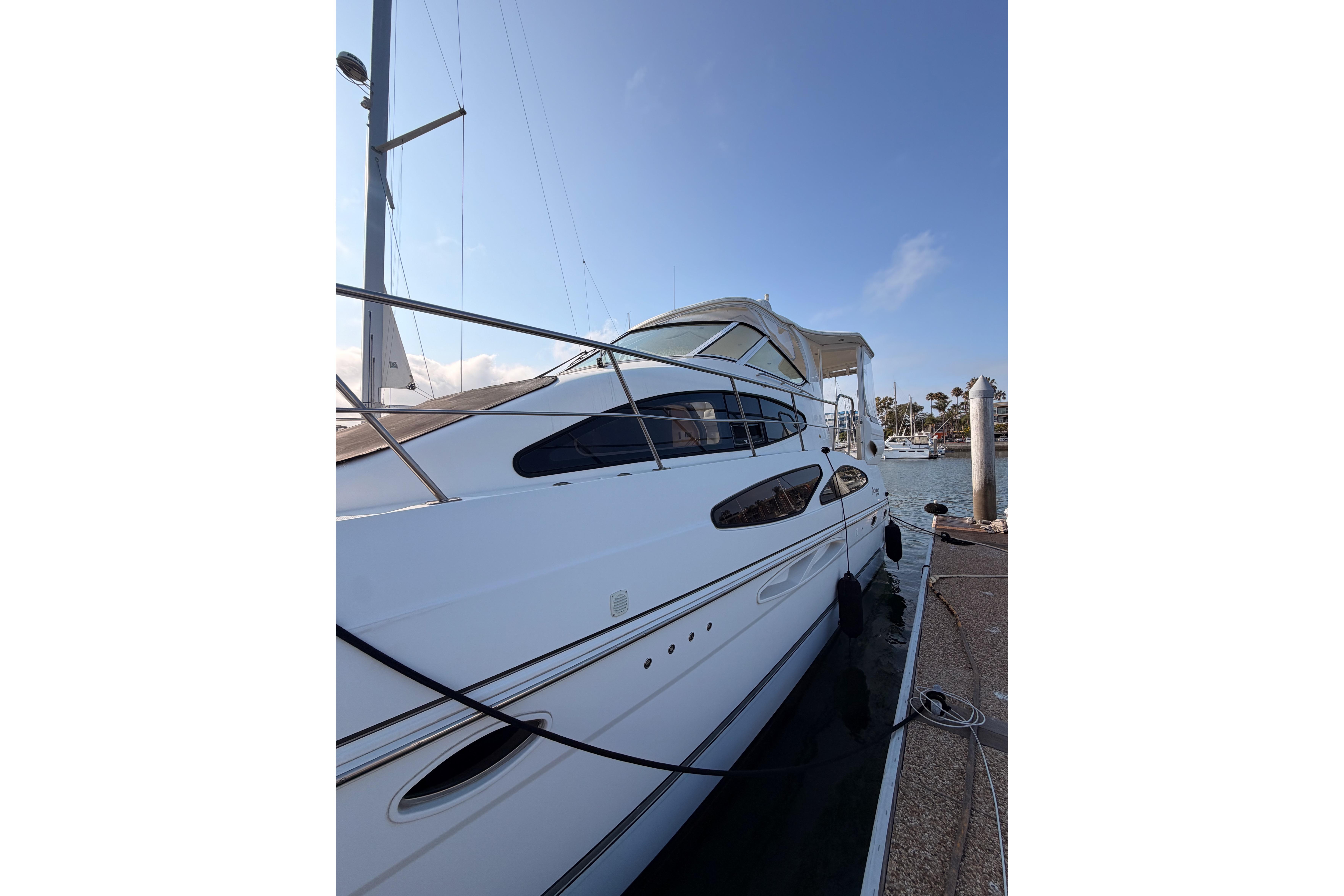 2005 Cruisers Yachts 405 Express Motoryacht docked at marina, side view.