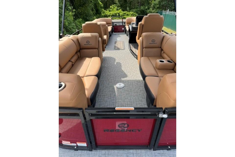 2026 Regency 230 DL pontoon boat interior with tan seating and cup holders.