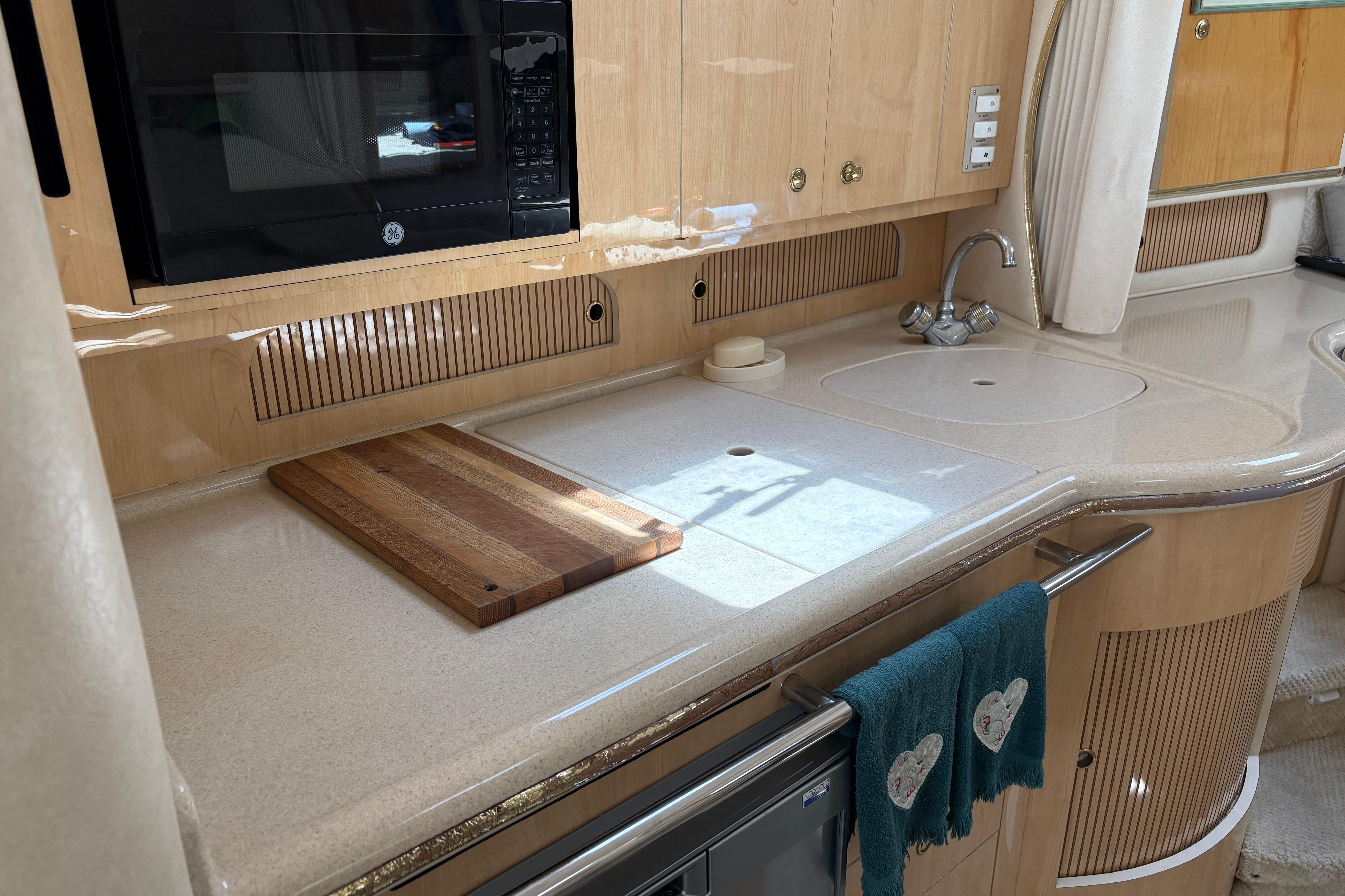 Luxurious kitchen area in a 2001 Sea Ray Sundancer 310 yacht, featuring modern amenities.