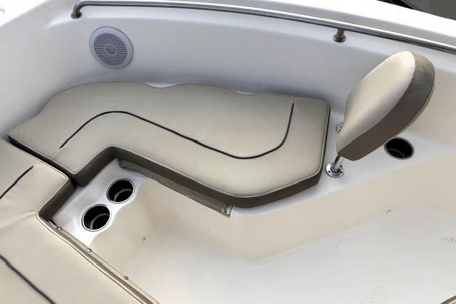 2023 Key West 203 FS boat interior with cushioned seating and cup holders.
