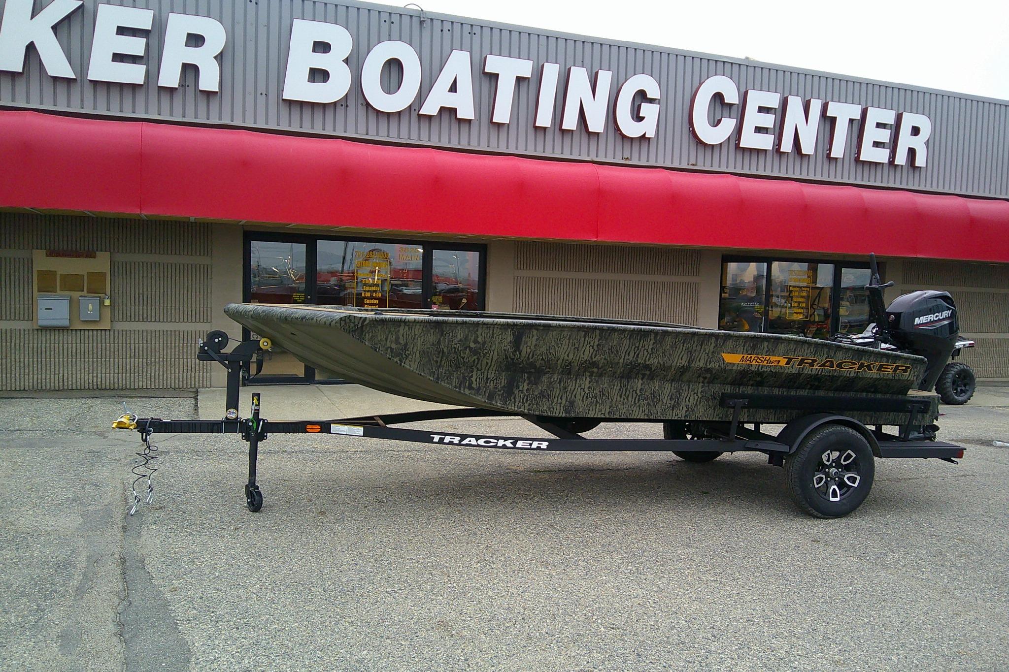 2026 Tracker Grizzly 1756 T Marsh boat on trailer outside boating center.