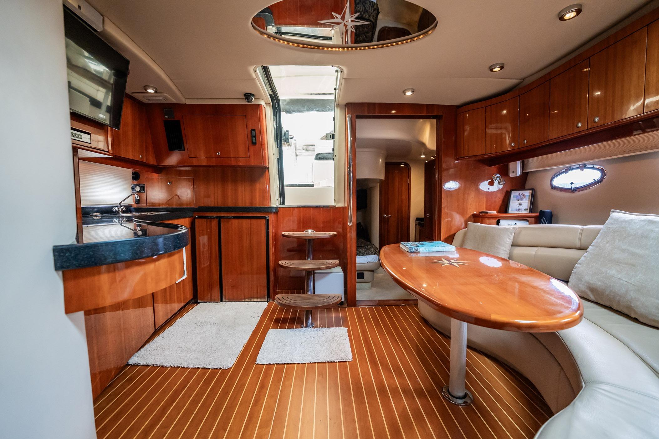 Luxurious interior of 2008 Regal Commodore 4460 yacht with wood finishes and modern amenities.