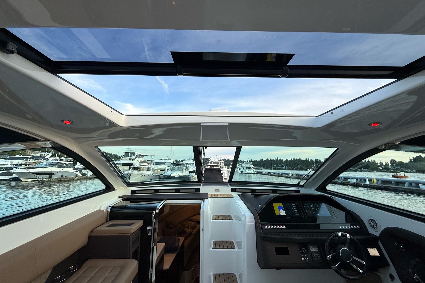 Interior view of 2017 Cobalt A40 Coupe yacht with panoramic windows and modern dashboard.