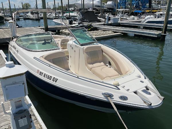 2006 Chaparral 256 SSi boat docked at marina, featuring sleek design and comfortable seating.