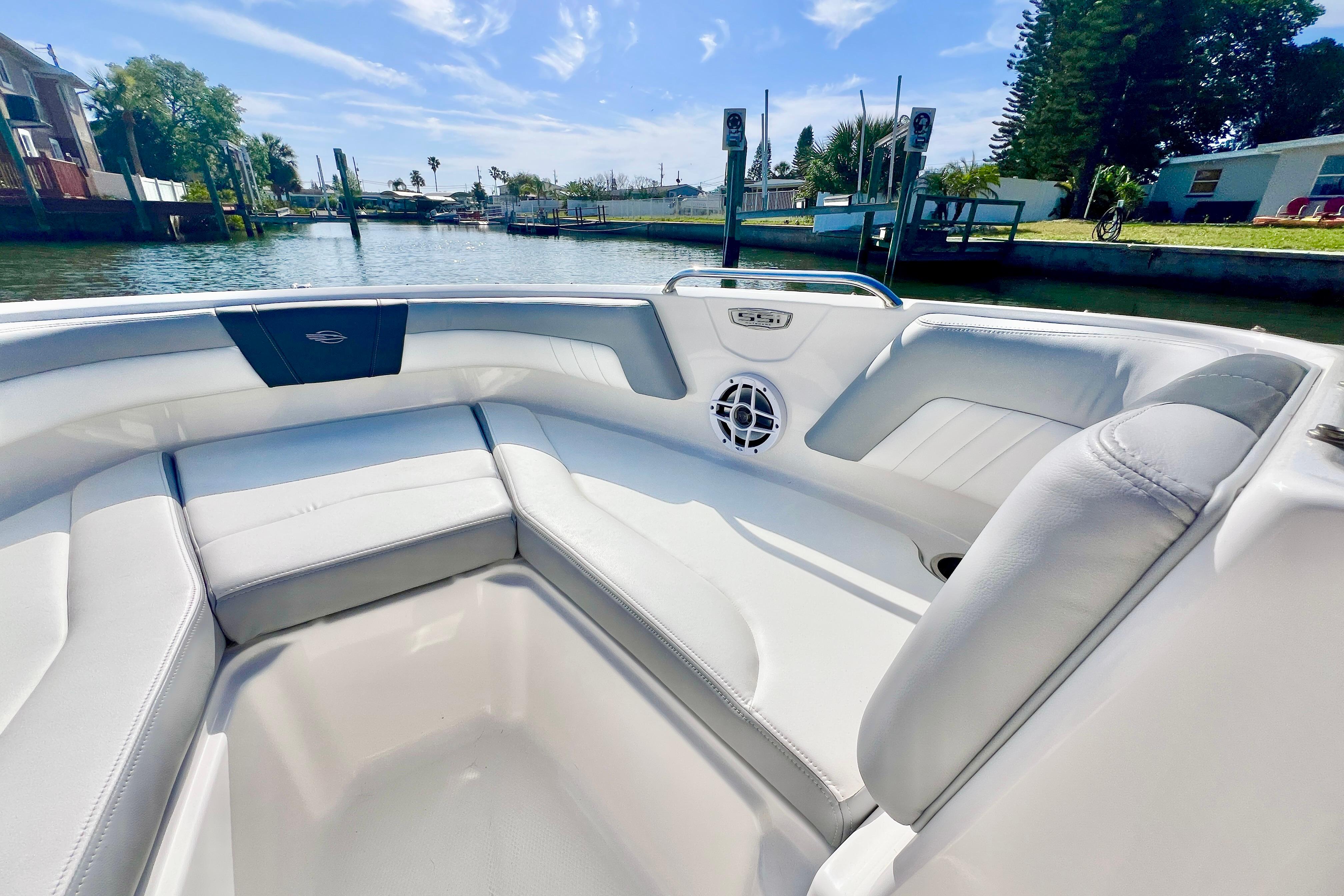 2023 Chaparral 21 SSi OB boat interior with white seating and waterfront view.