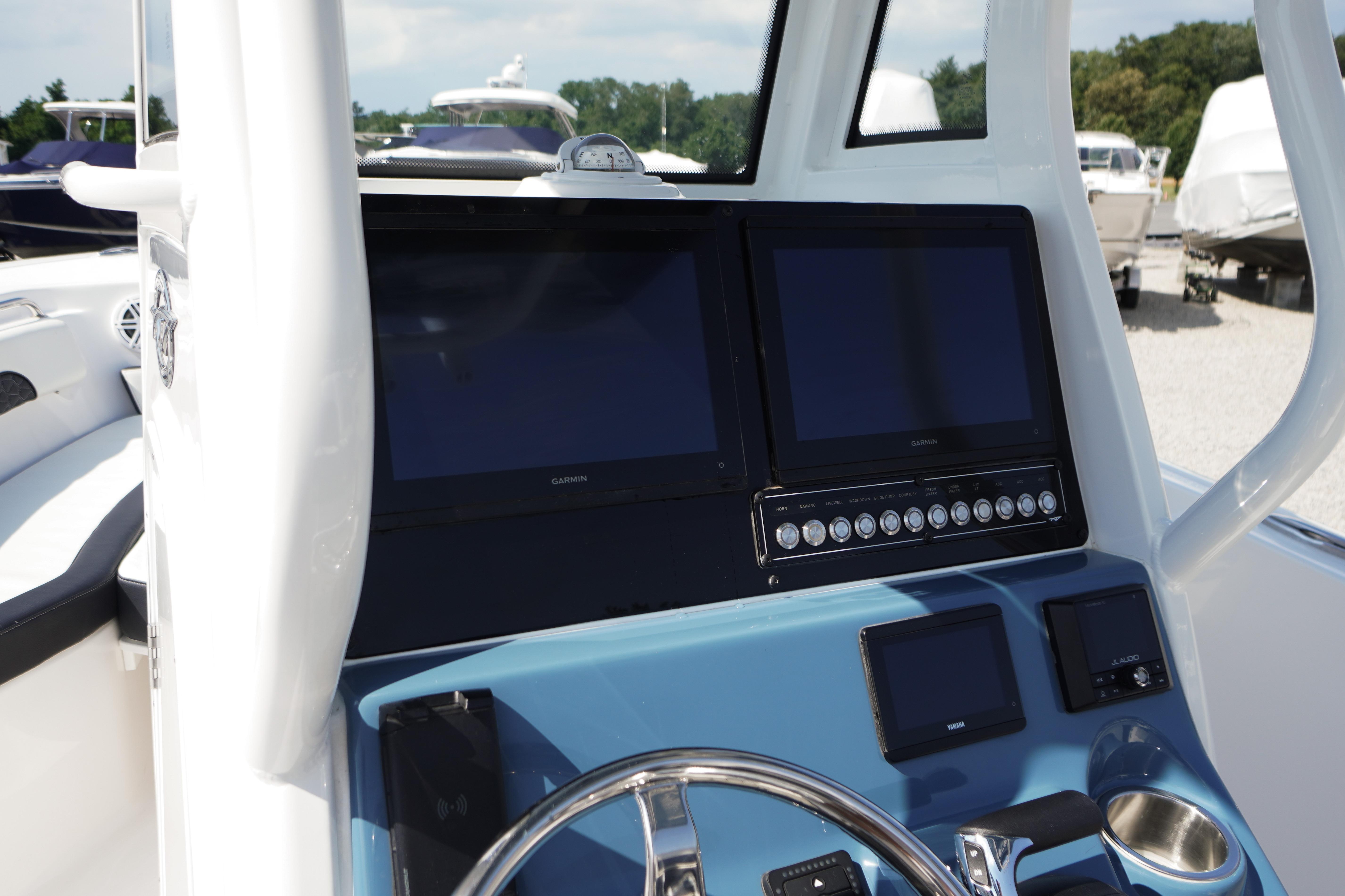 2025 Tidewater 232 SS boat dashboard with dual Garmin displays and control panel.