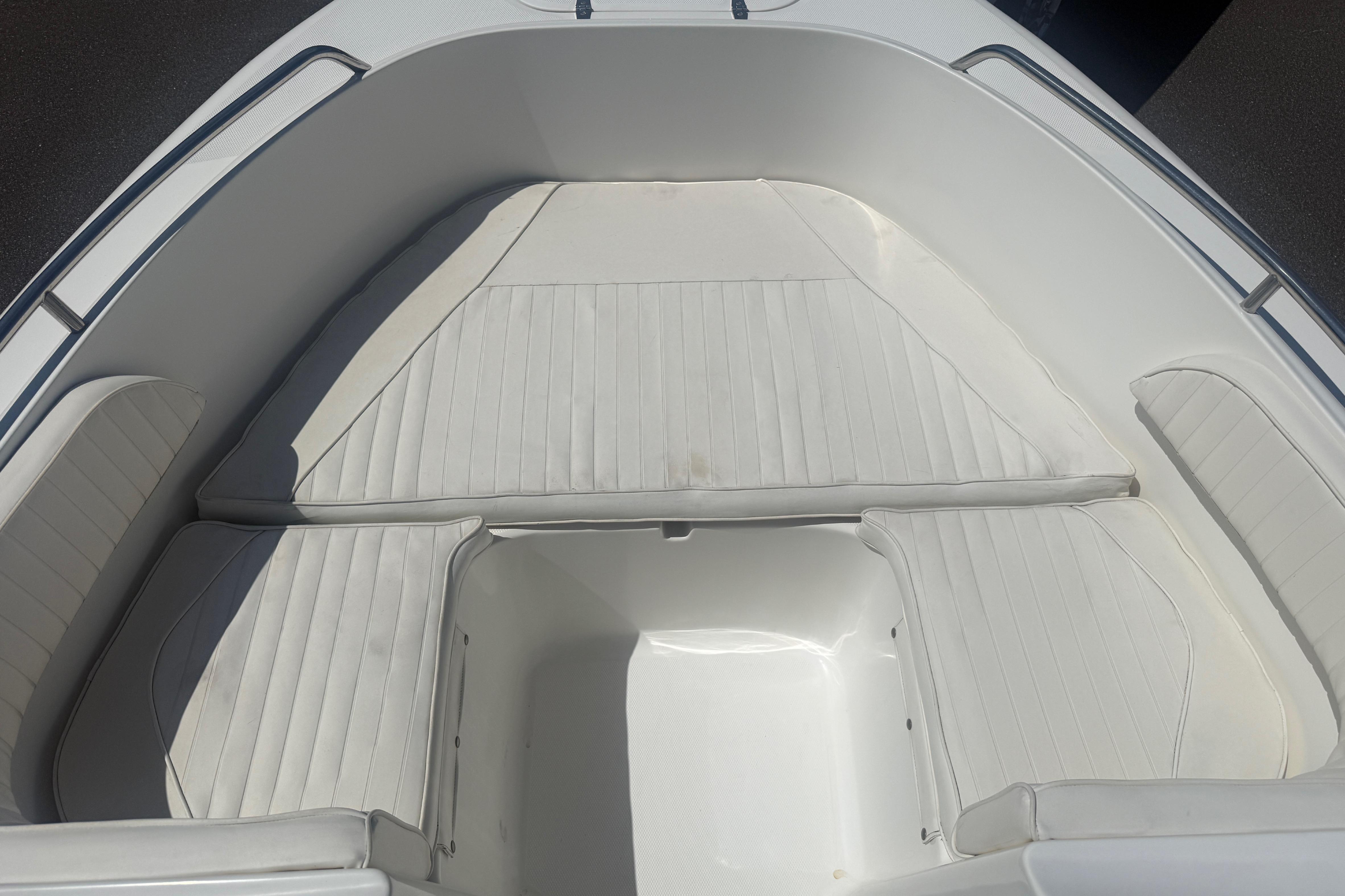 Interior seating of a 2006 Sea Hunt Escape 200 boat, featuring white cushioned seats.