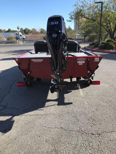 2025 Tracker Bass Tracker Classic XL boat with 50 HP engine, parked outdoors.