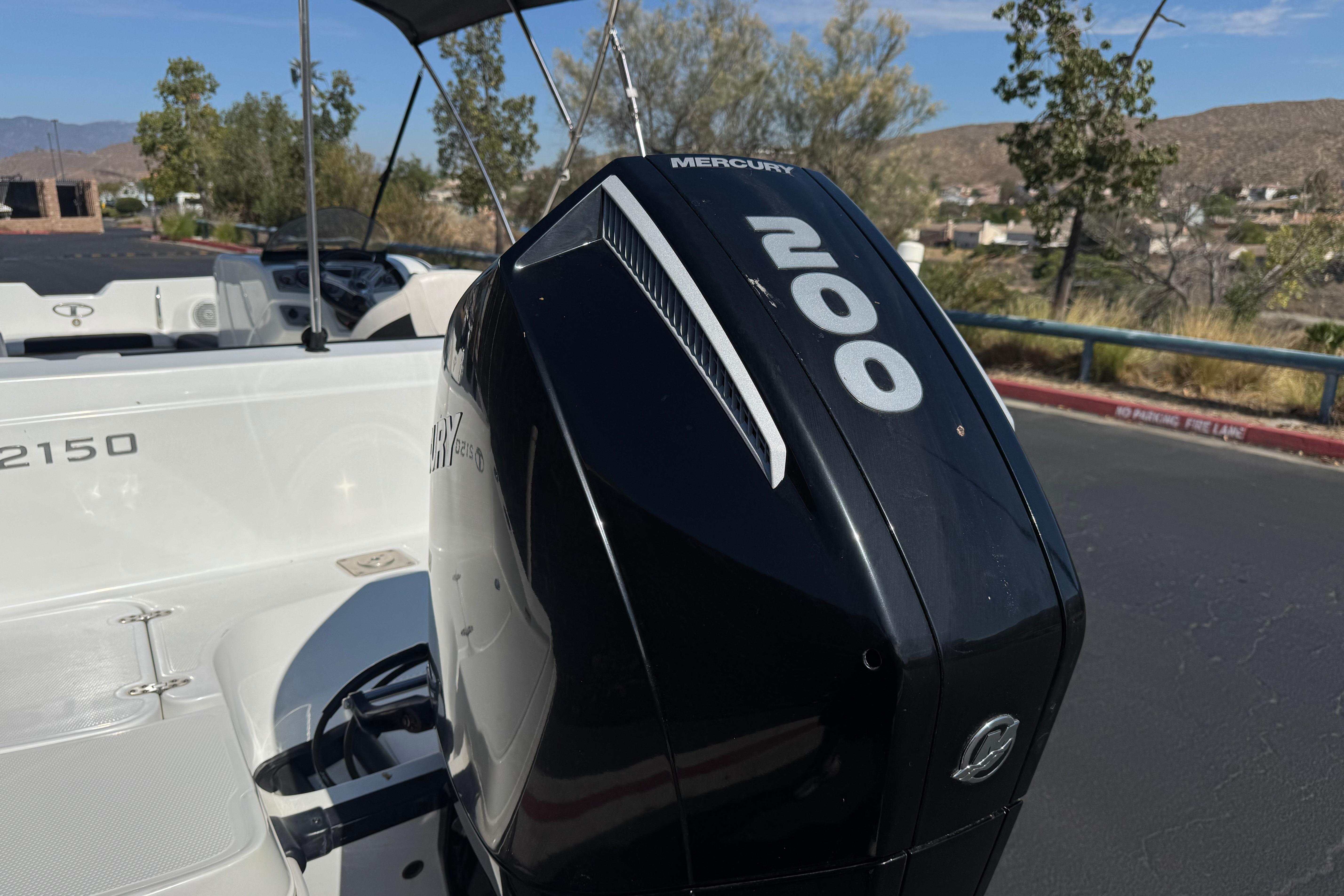 2019 Tahoe 2150 boat with Mercury 200 outboard motor in a scenic outdoor setting.