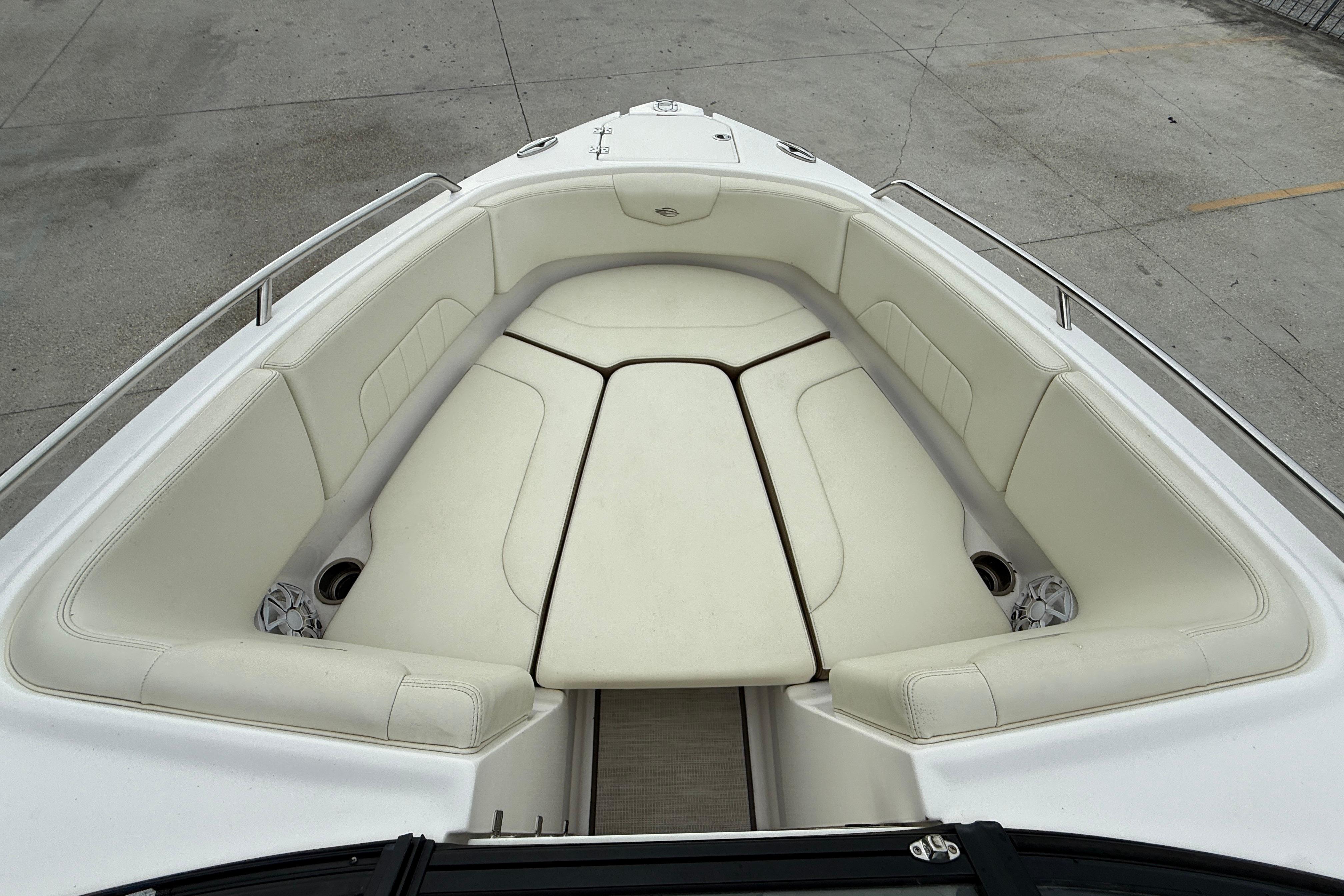 2018 Chaparral 227 SSX Surf boat with spacious white seating area.