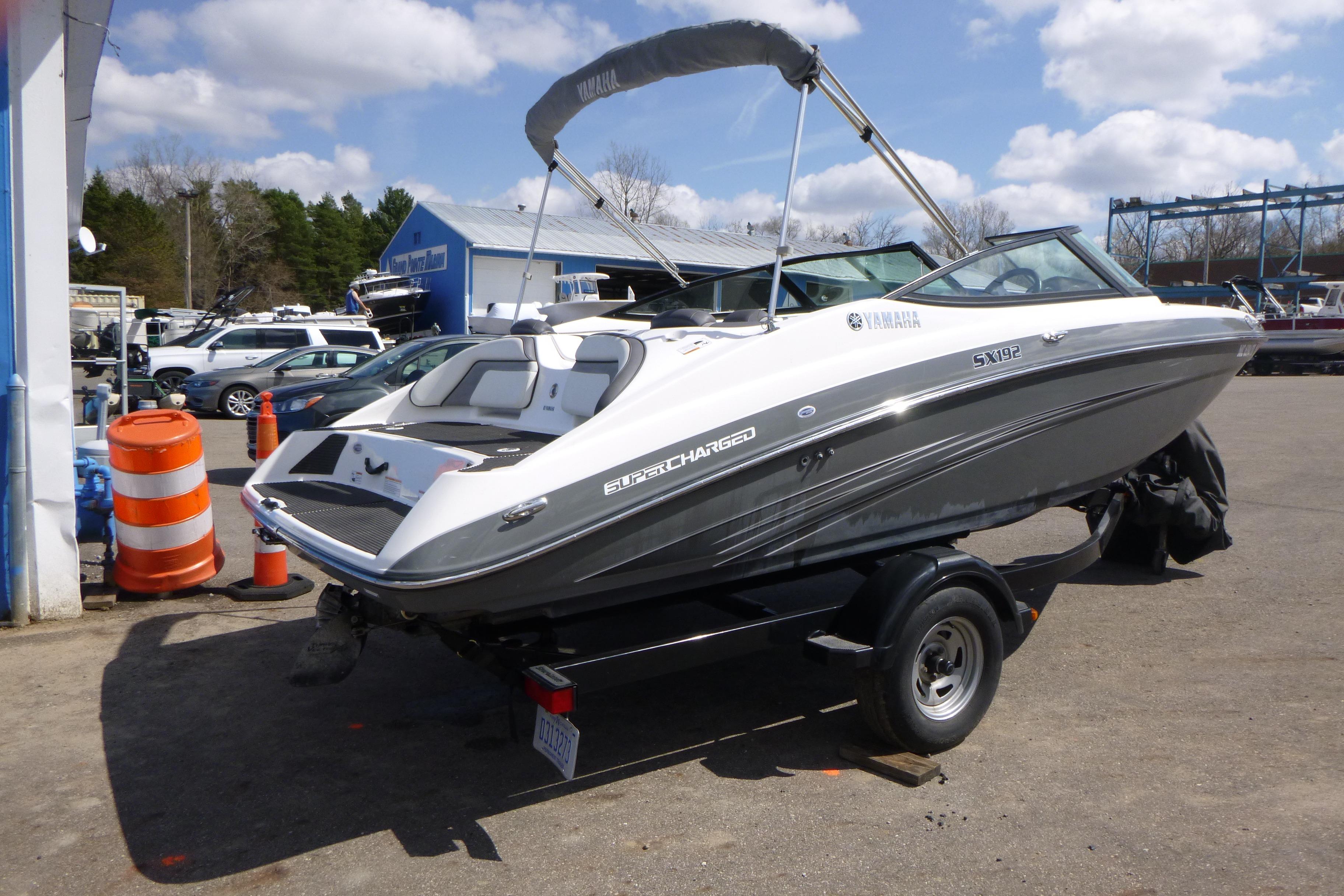 2015 Yamaha Boats SX192 on trailer, parked outdoors under a cloudy sky.