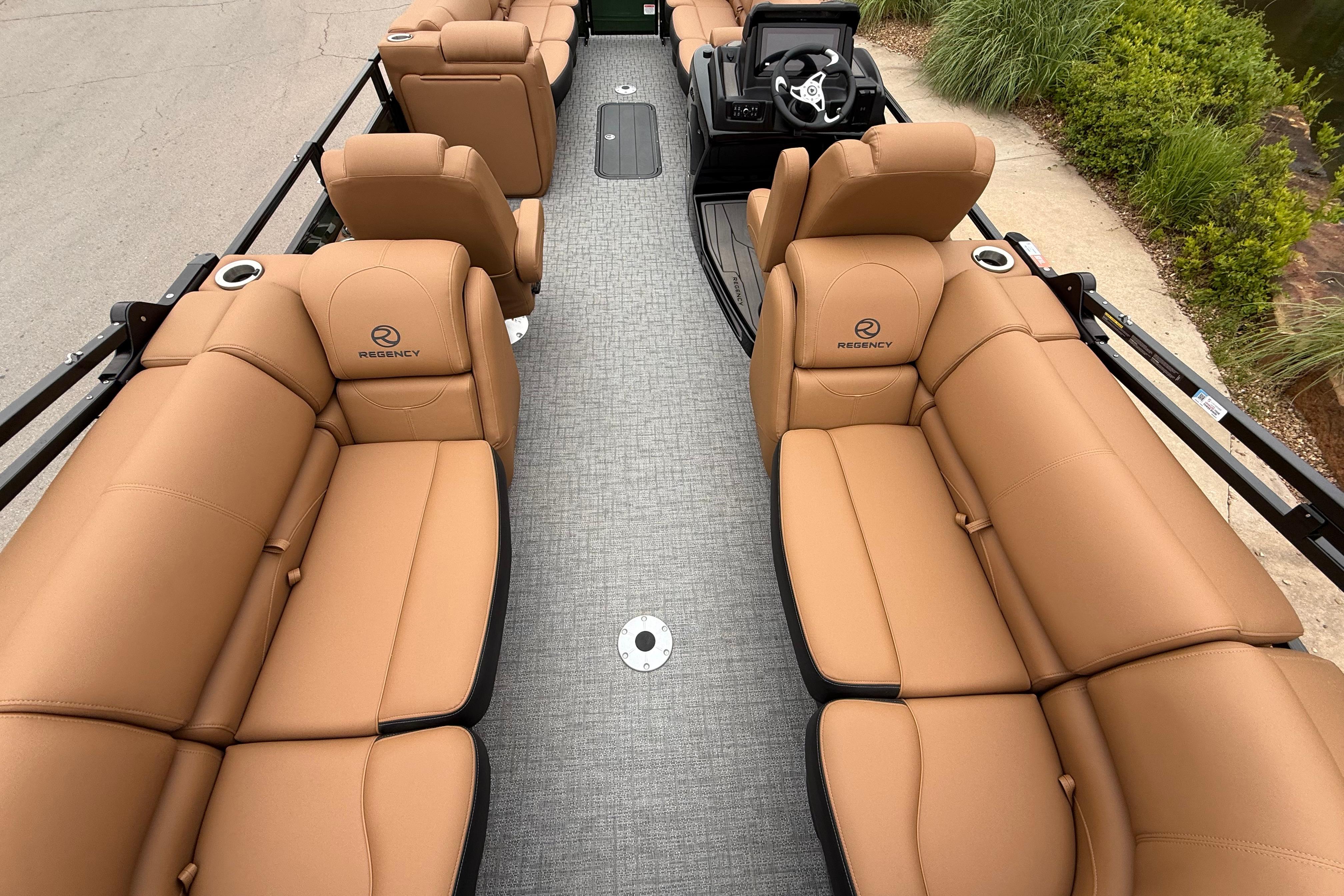 Luxurious interior of 2026 Regency 250 DL pontoon boat with tan leather seating.