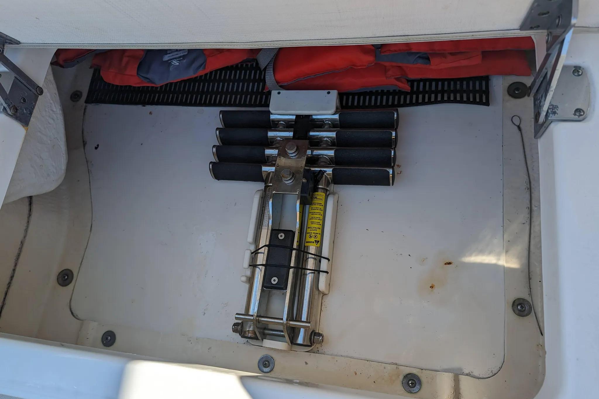 Storage compartment of a 2017 Boston Whaler 320 Vantage with safety equipment.