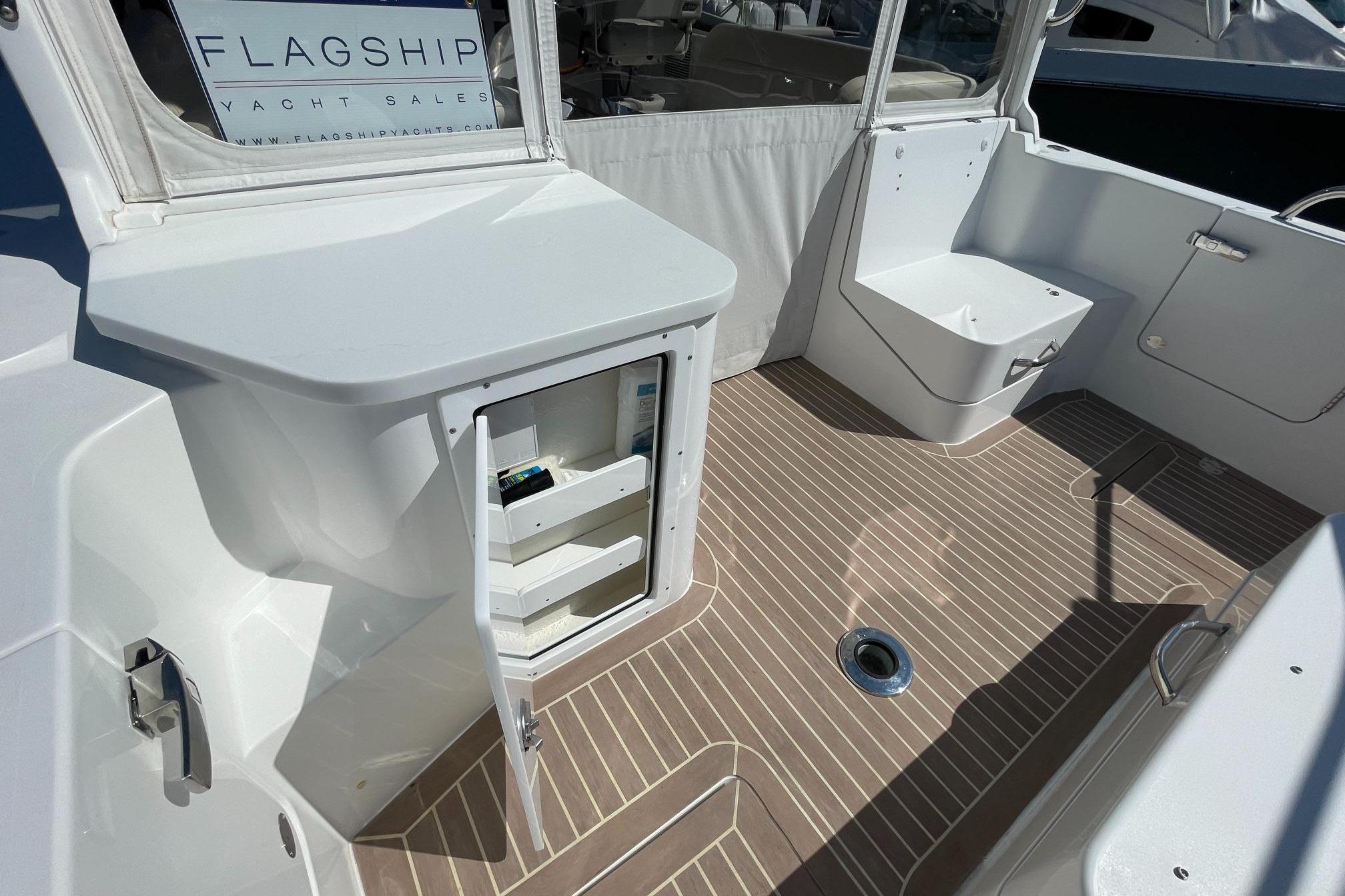 2023 MJM 35 yacht interior with open storage, sleek design, and wood-patterned flooring.