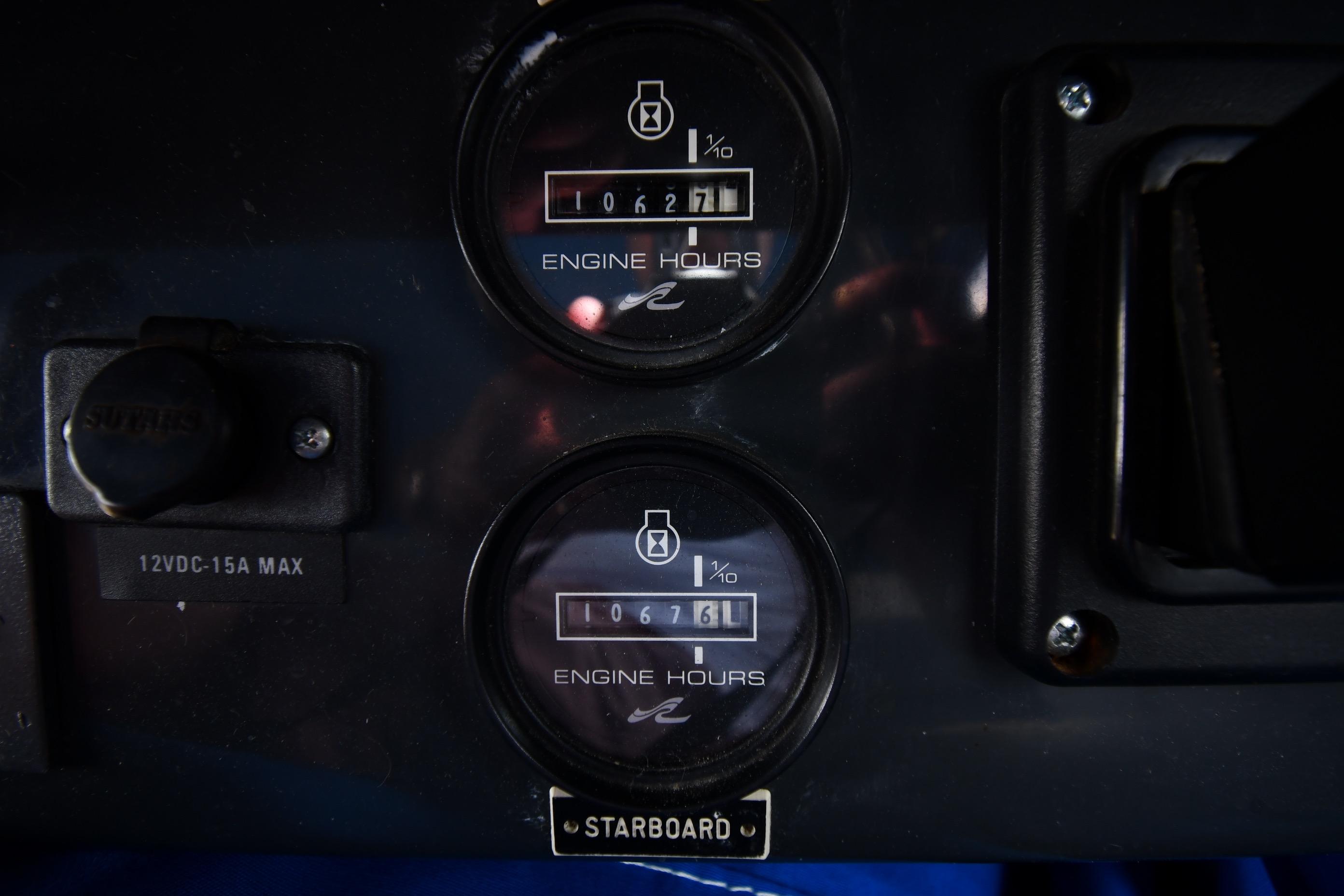 1993 Sea Ray 300 Sundancer engine hour meters displaying 1067.1 and 1067.6 hours.