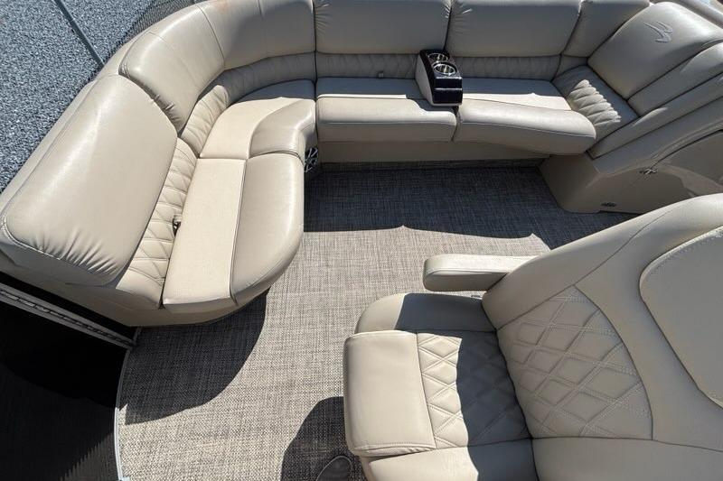 Luxurious seating on a 2014 Bennington 2575 RCW pontoon boat with beige upholstery.