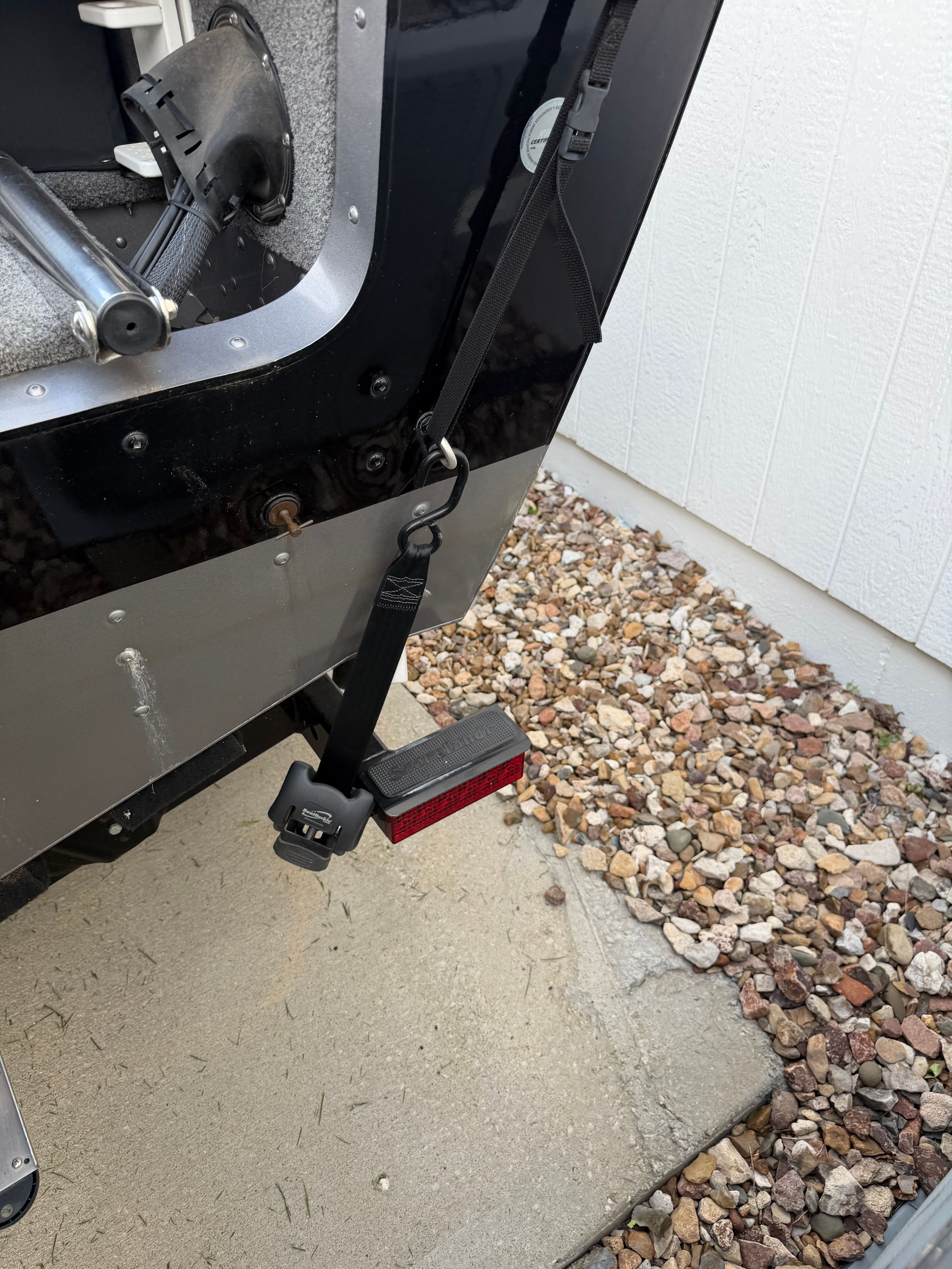 Rear of 2017 Lund Pro V 1975 boat with trailer strap.