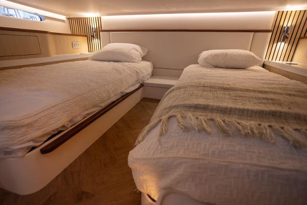 Manufacturer Provided Image: Luxurious twin beds in 2026 Regal LX43 yacht cabin, featuring modern design and cozy lighting.