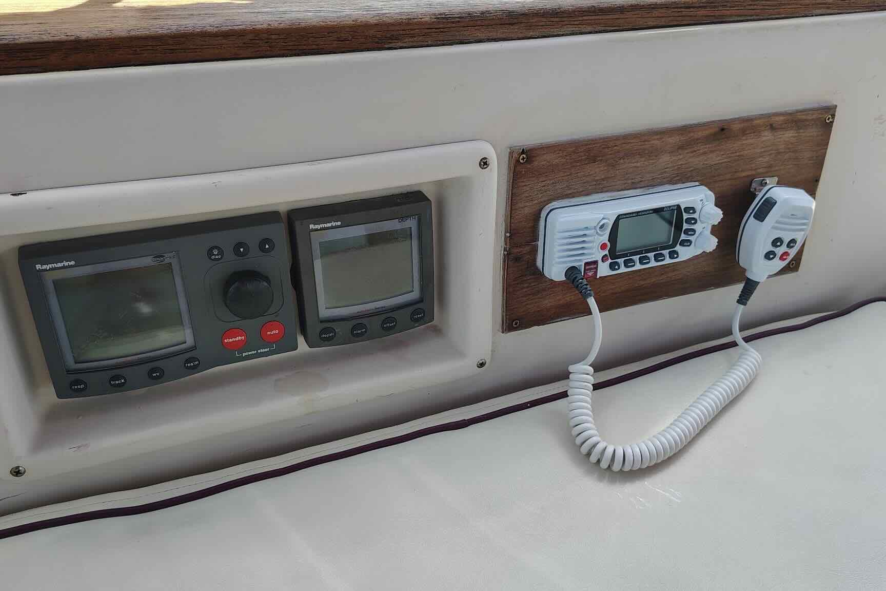 Control panel of a 1989 Island Packet 35 sailboat with navigation and communication equipment.