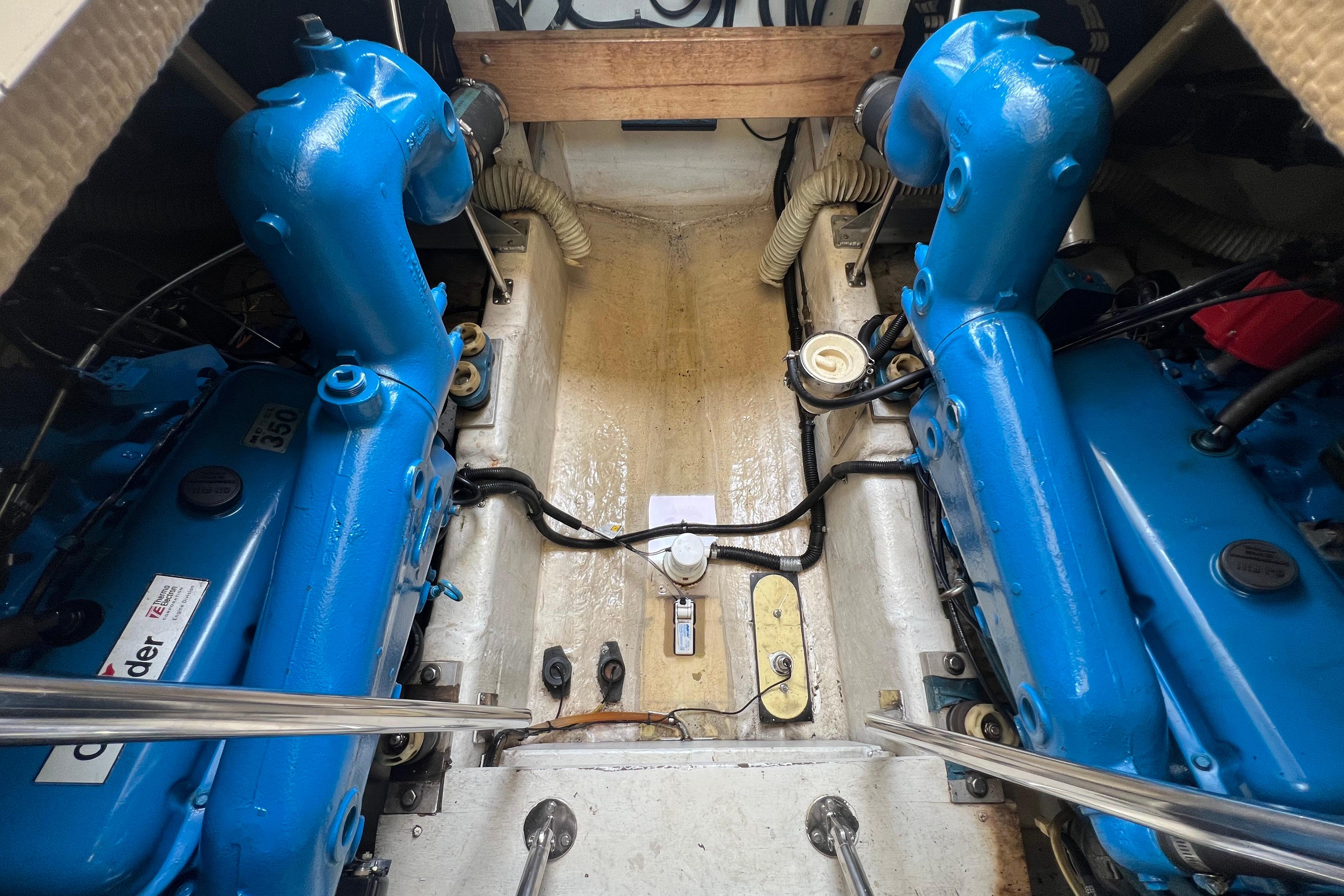 Engine room of a 1985 Tiara 36 OPEN boat with blue engines.