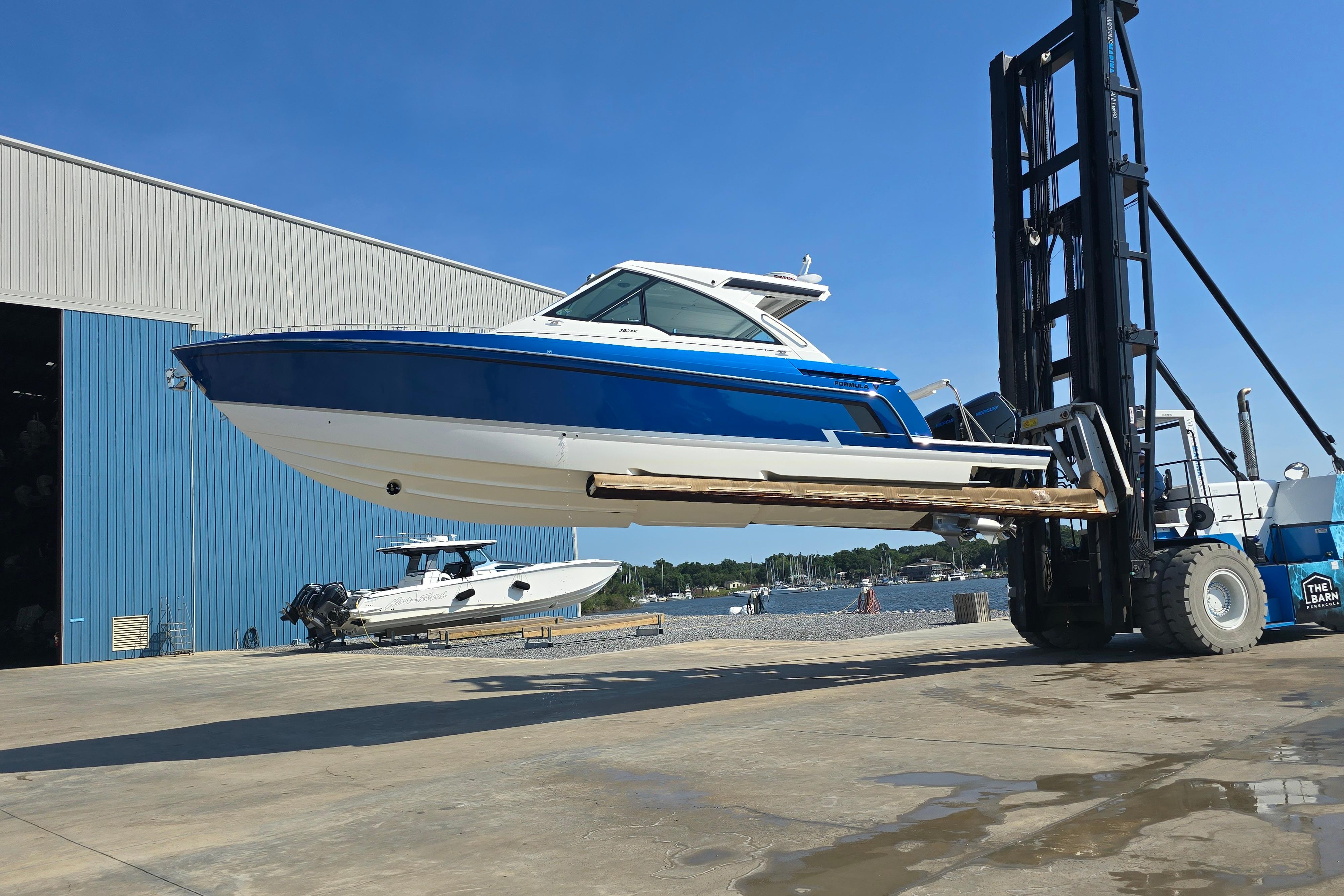 2025 Formula 380 Super Sport Crossover OB lifted by forklift near marina.