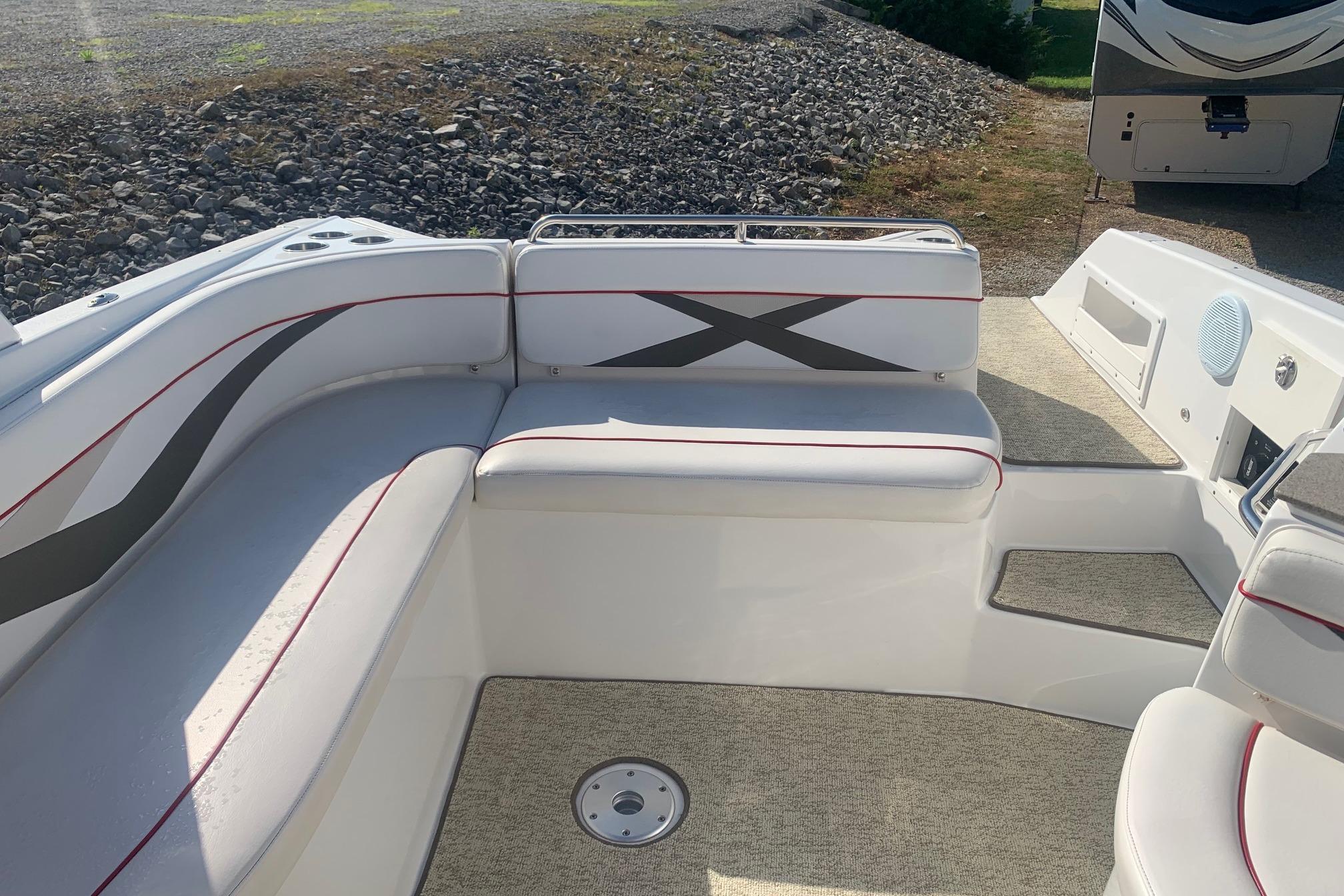 2006 Rinker 282 Captiva Cuddy boat interior with white seating and red accents.