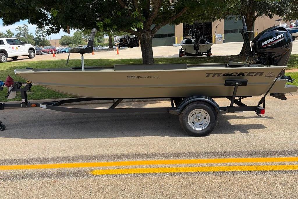 2026 Tracker Grizzly 1654 T Sportsman boat on trailer, parked outdoors.