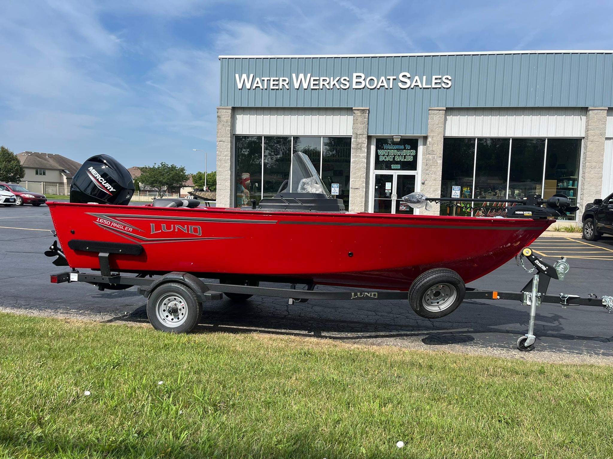 2026 Lund 1650 Angler SS boat in red, parked at Water Werks Boat Sales.