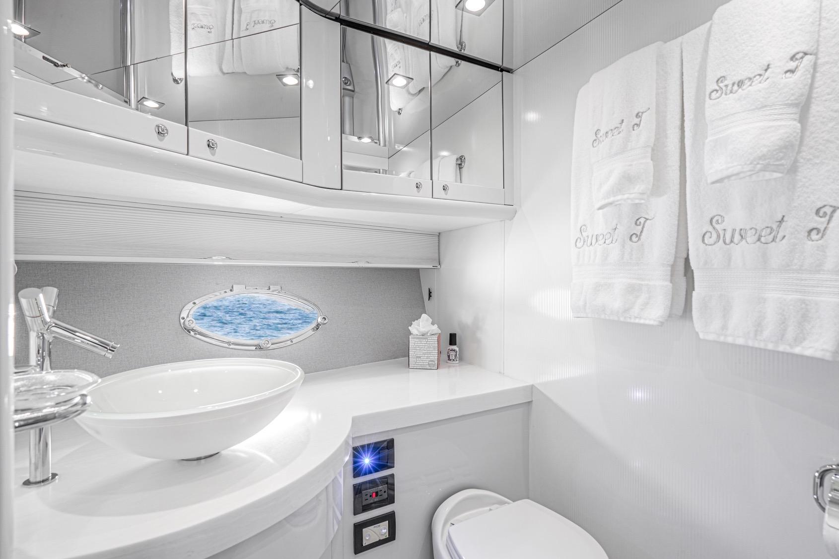 Luxurious bathroom in 2021 Sunseeker Predator 68 yacht with elegant fixtures and ocean view.
