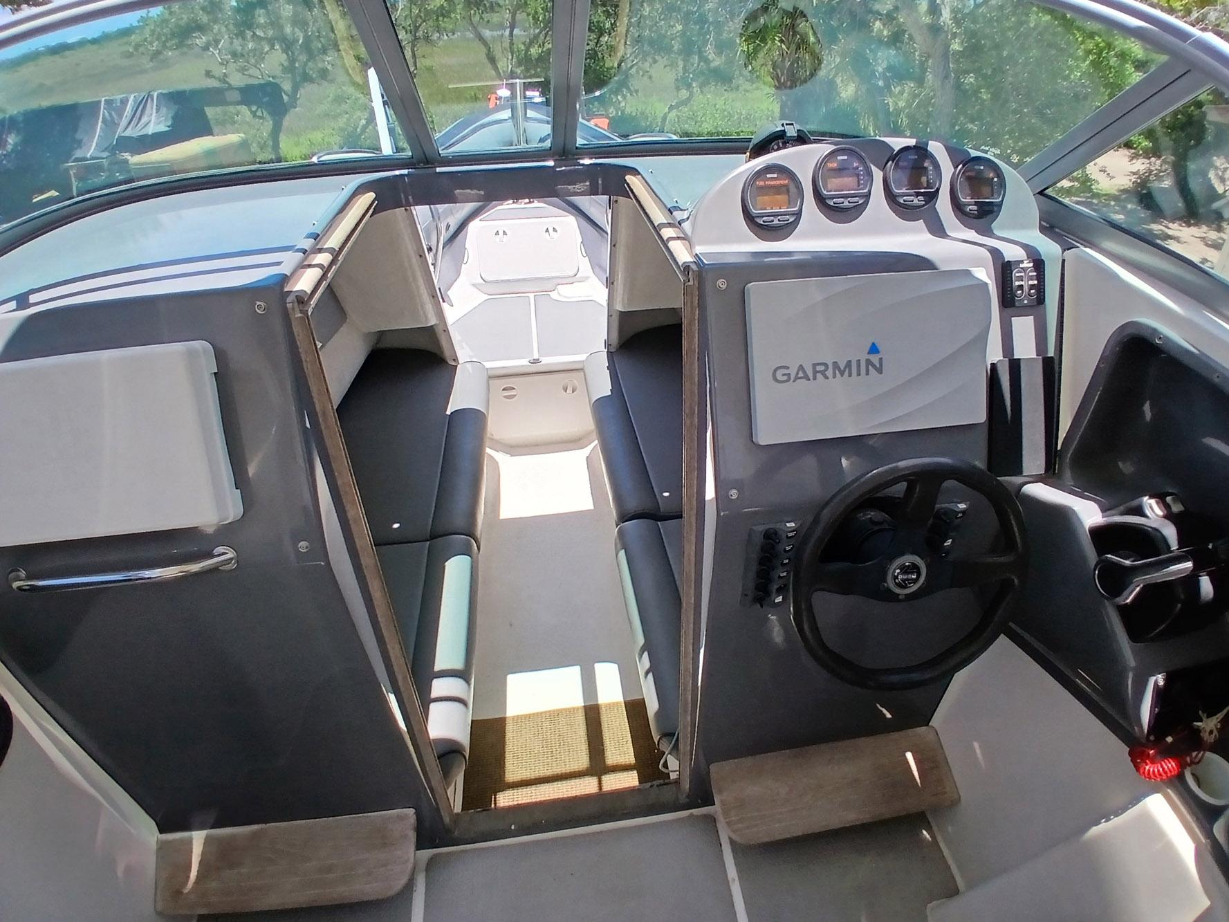 2002 Protector 28 Targa boat interior with Garmin navigation system and seating area.