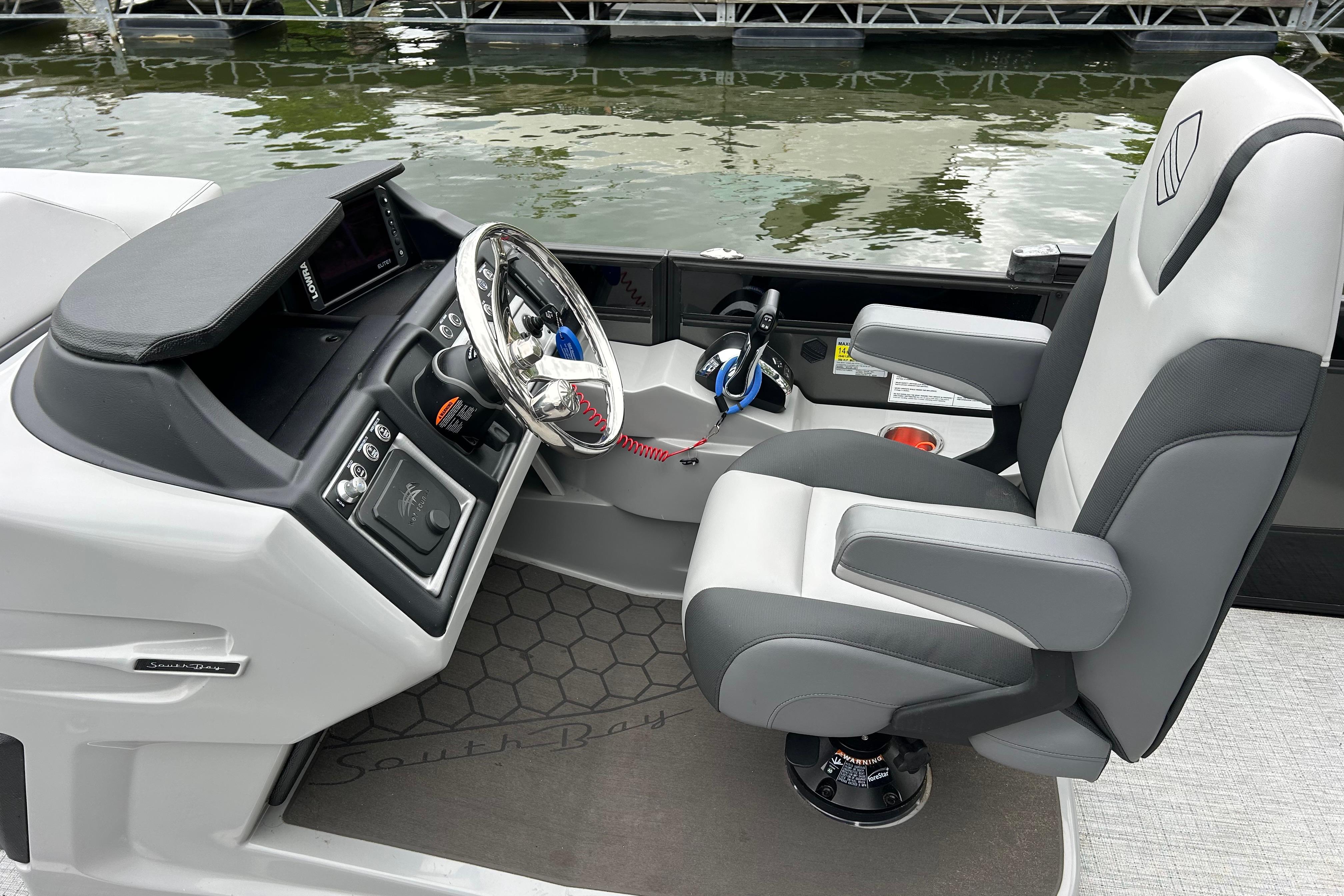 Modern 2025 South Bay 525UL393 boat cockpit with sleek steering and comfortable seating.
