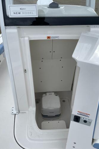 2026 Robalo 246 Cayman boat interior with compact toilet compartment.