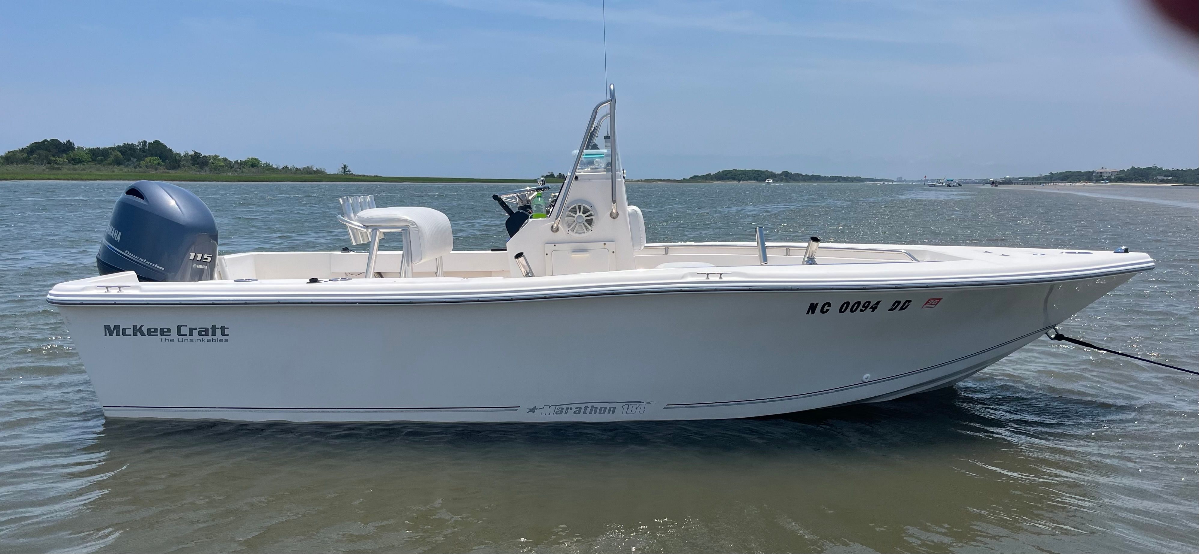 A white McKee Craft Marathon 184 CC boat on calm water.