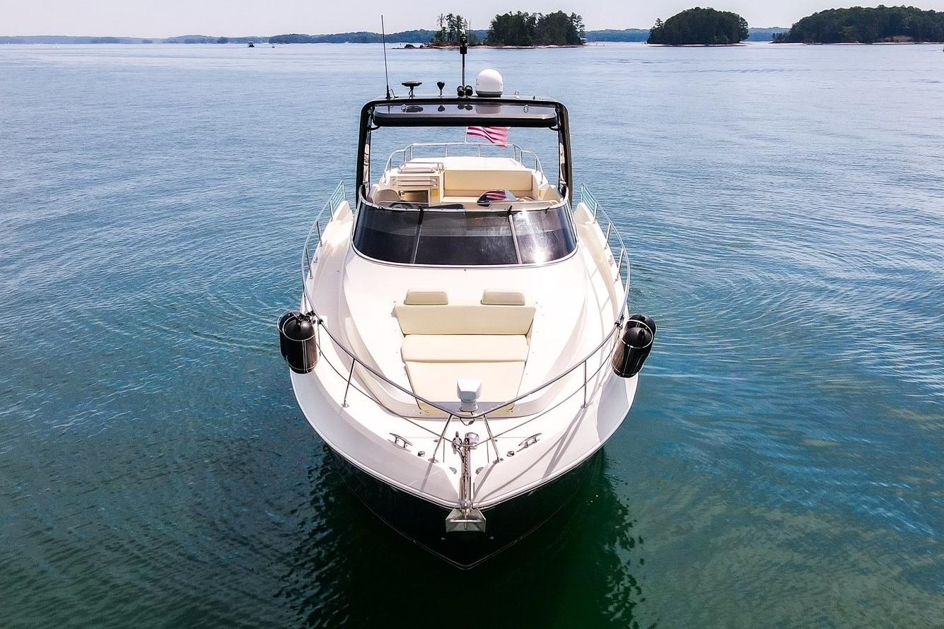 2011 Carver 44 Sojourn yacht on serene water with distant islands.