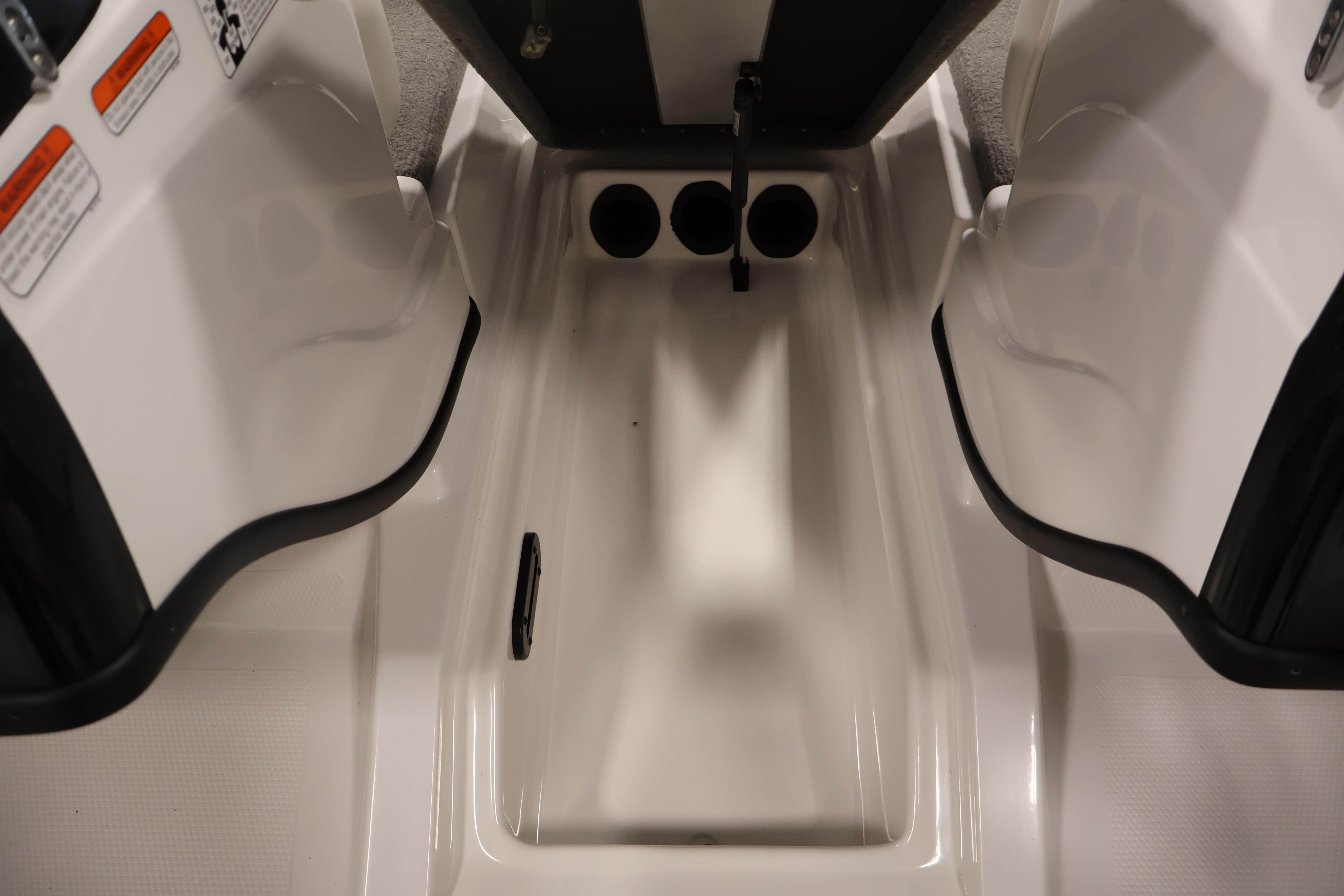 2019 Nitro Z19 Sport boat interior storage compartment with open lids and cup holders.