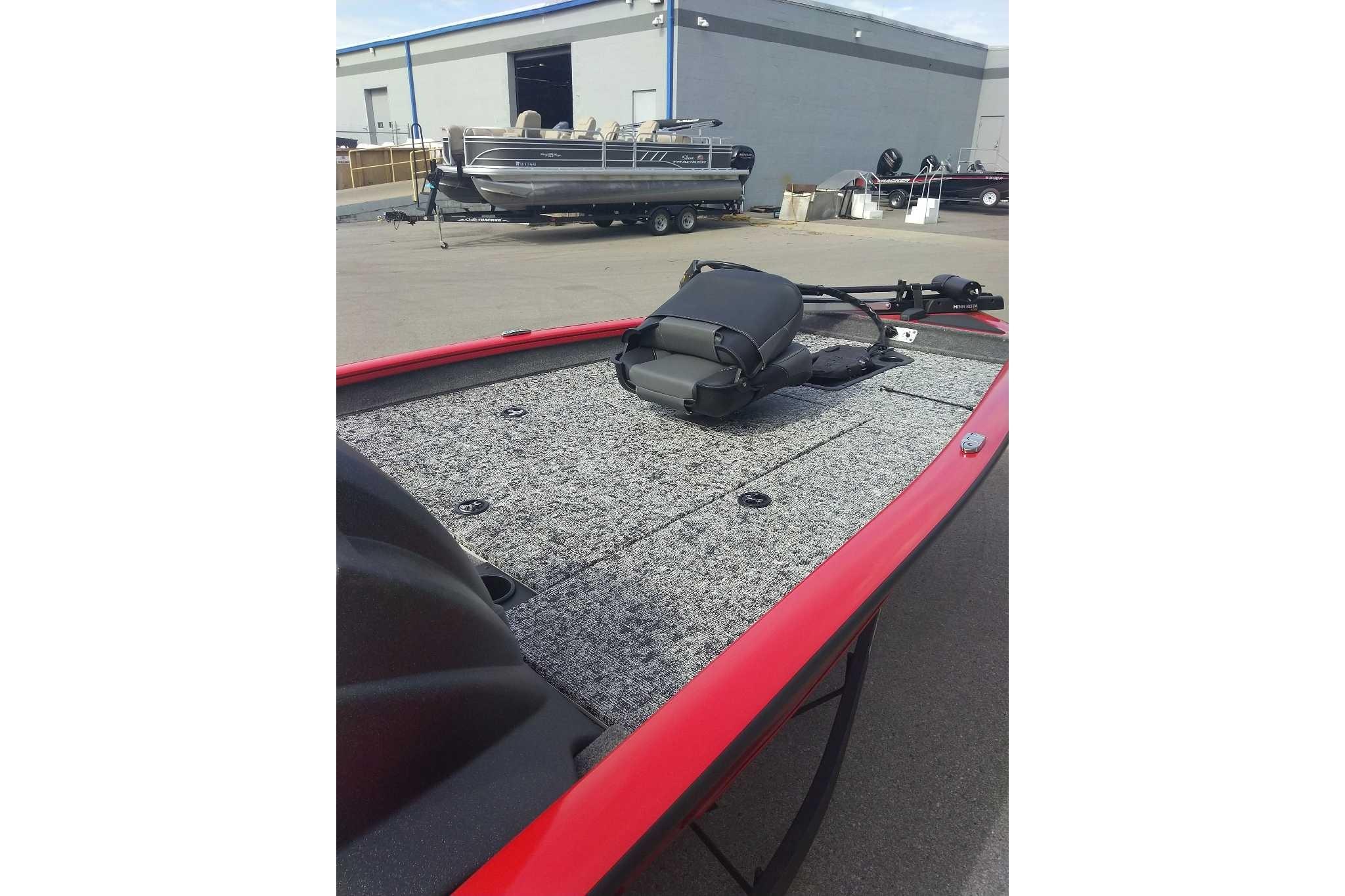 2026 Tracker Pro Team 190 boat with red trim and carpeted deck.