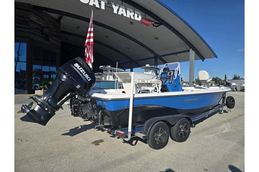 2020 Blue Wave 2400 PureBay boat with Suzuki engine at a boat yard.