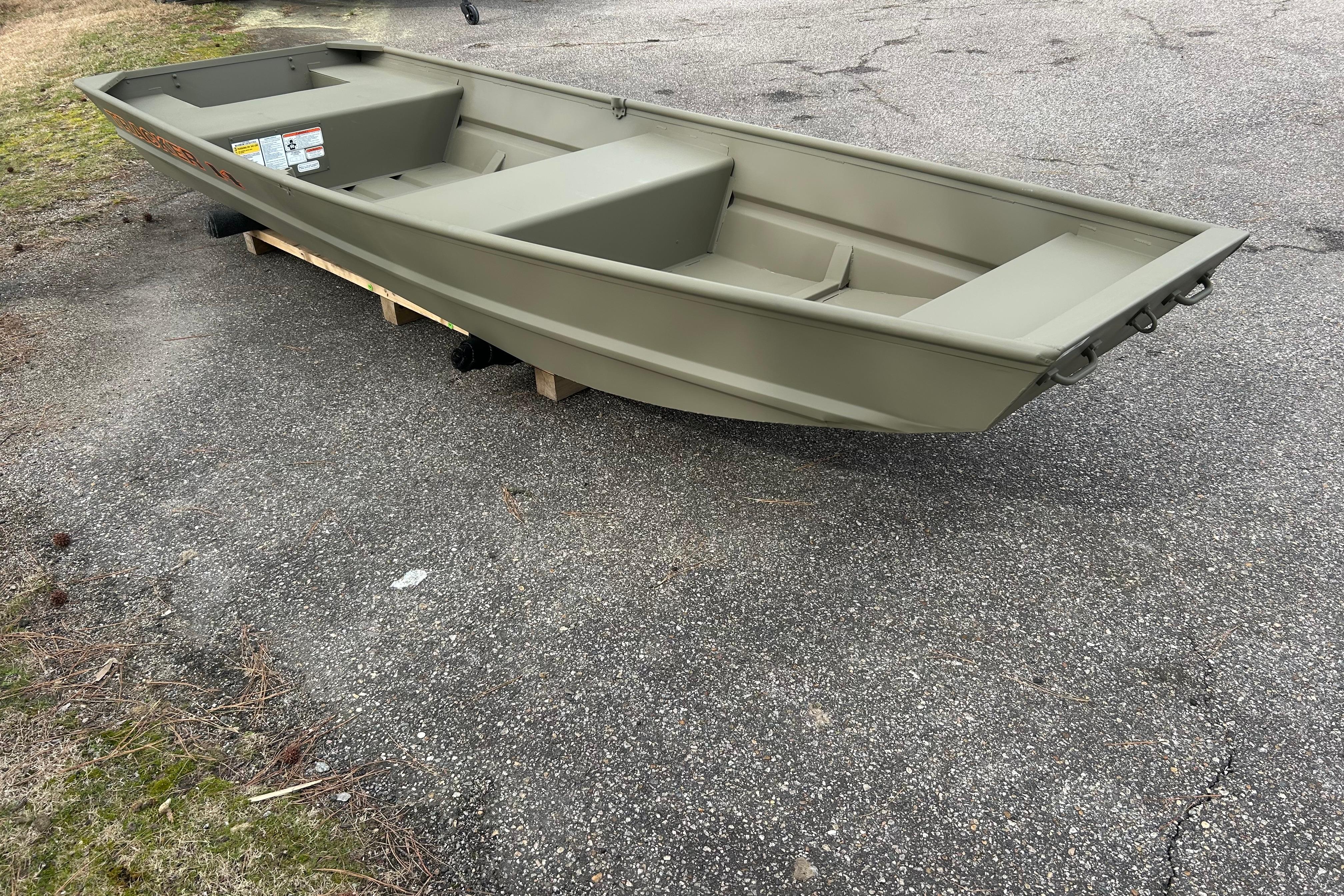 2026 Tracker Grizzly 14 Jon boat on pavement, showcasing its sturdy design.