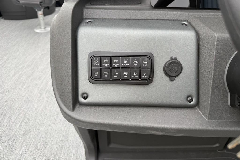 Control panel of 2026 Sun Tracker Fishin' Barge 20 DLX with USB port and switches.